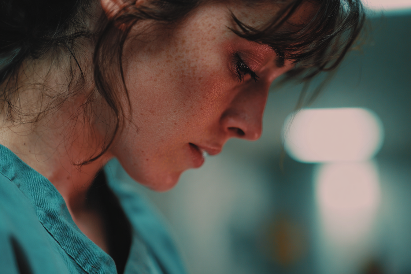 A woman looking down | Source: Midjourney