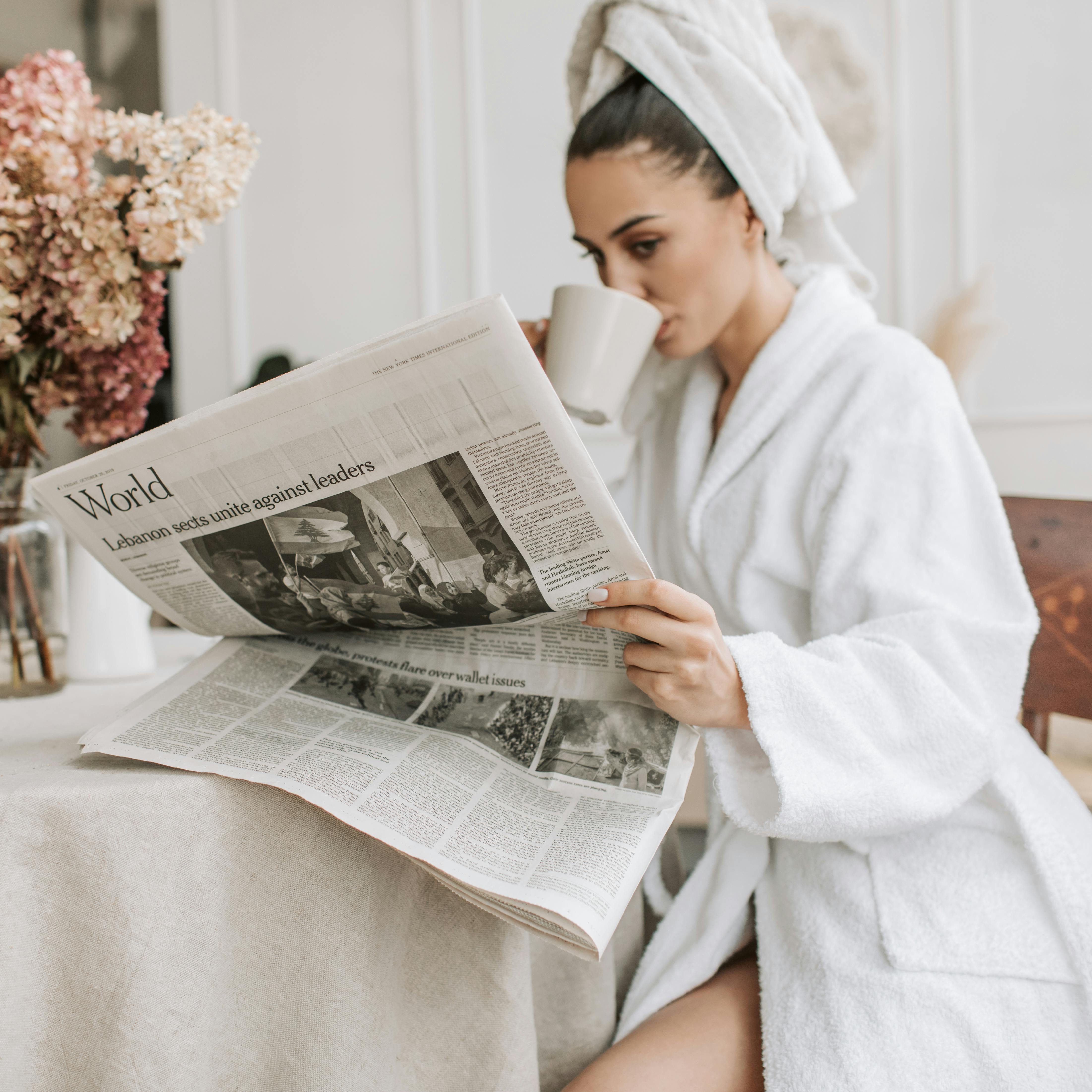 A woman in a robe drinking coffee | Source: Pexels