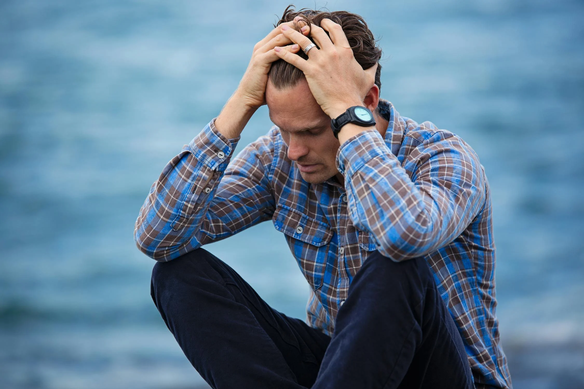 A sad man sitting by the sea | Source: Pexels