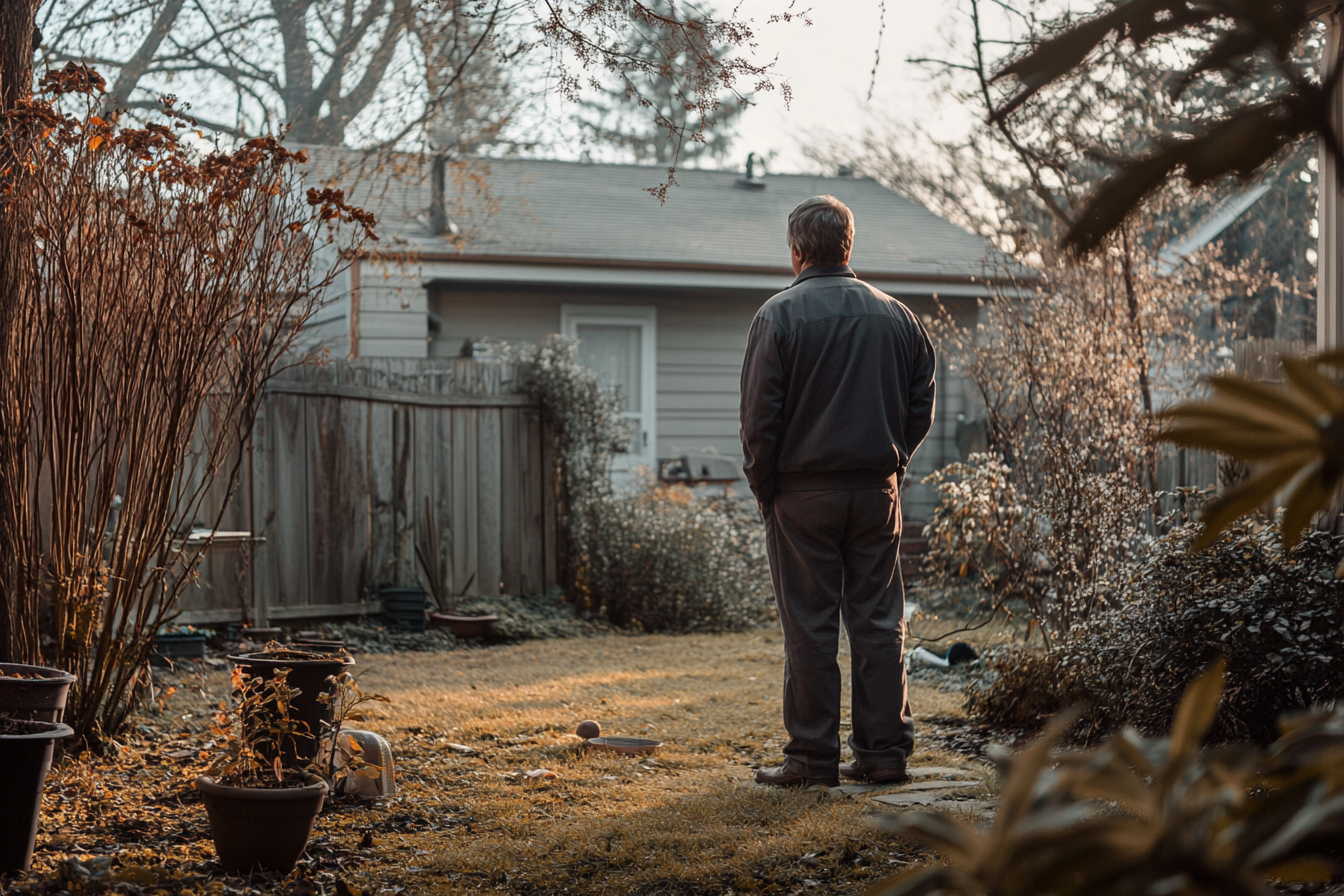A man standing in a backyard | Source: Midjourney