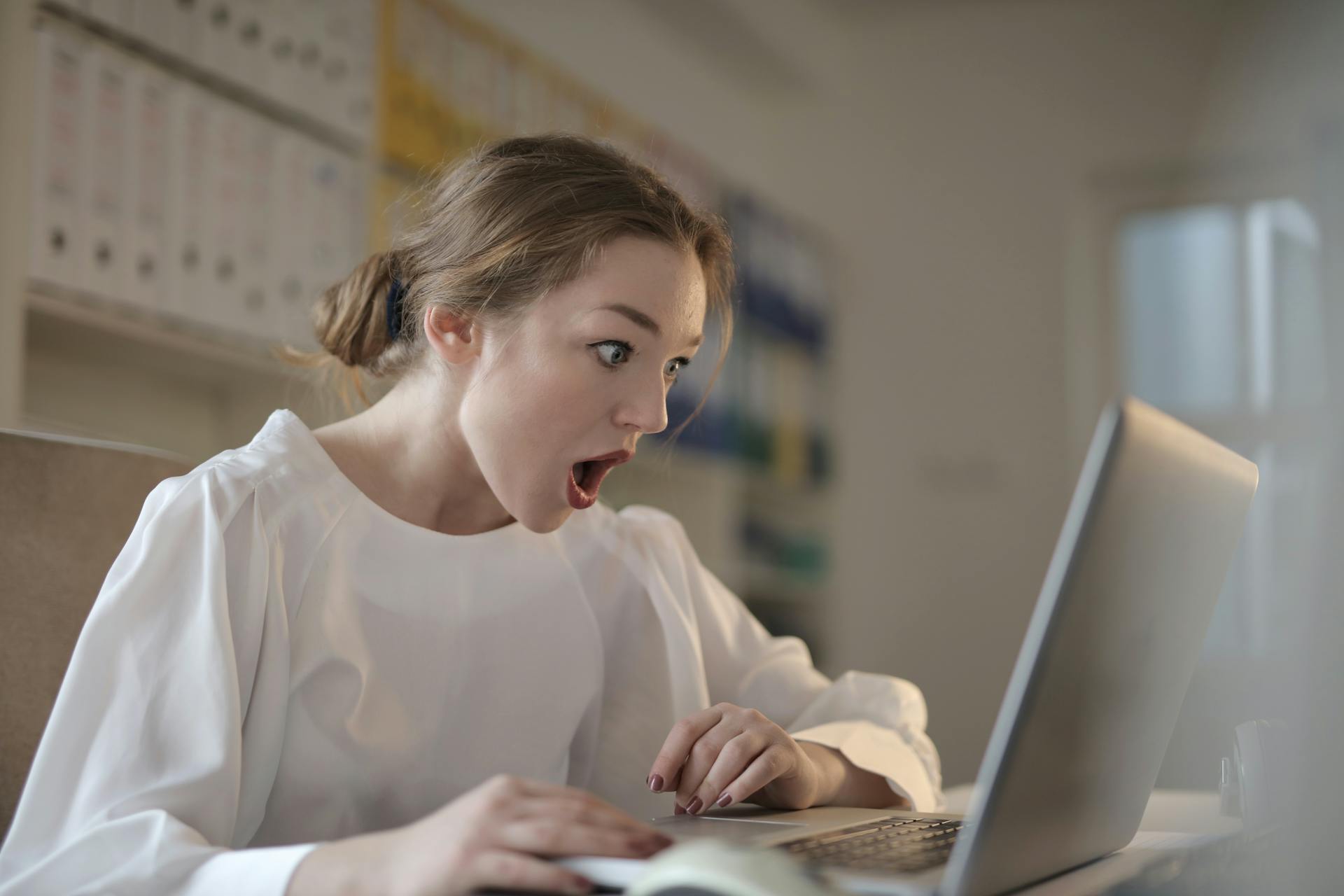 A woman staring at a laptop in shock | Source: Pexels