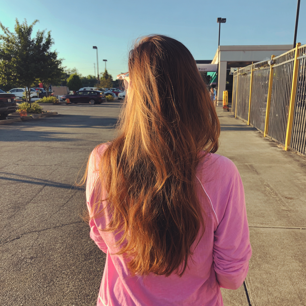 A woman walking through a parking lot | Source: Midjourney