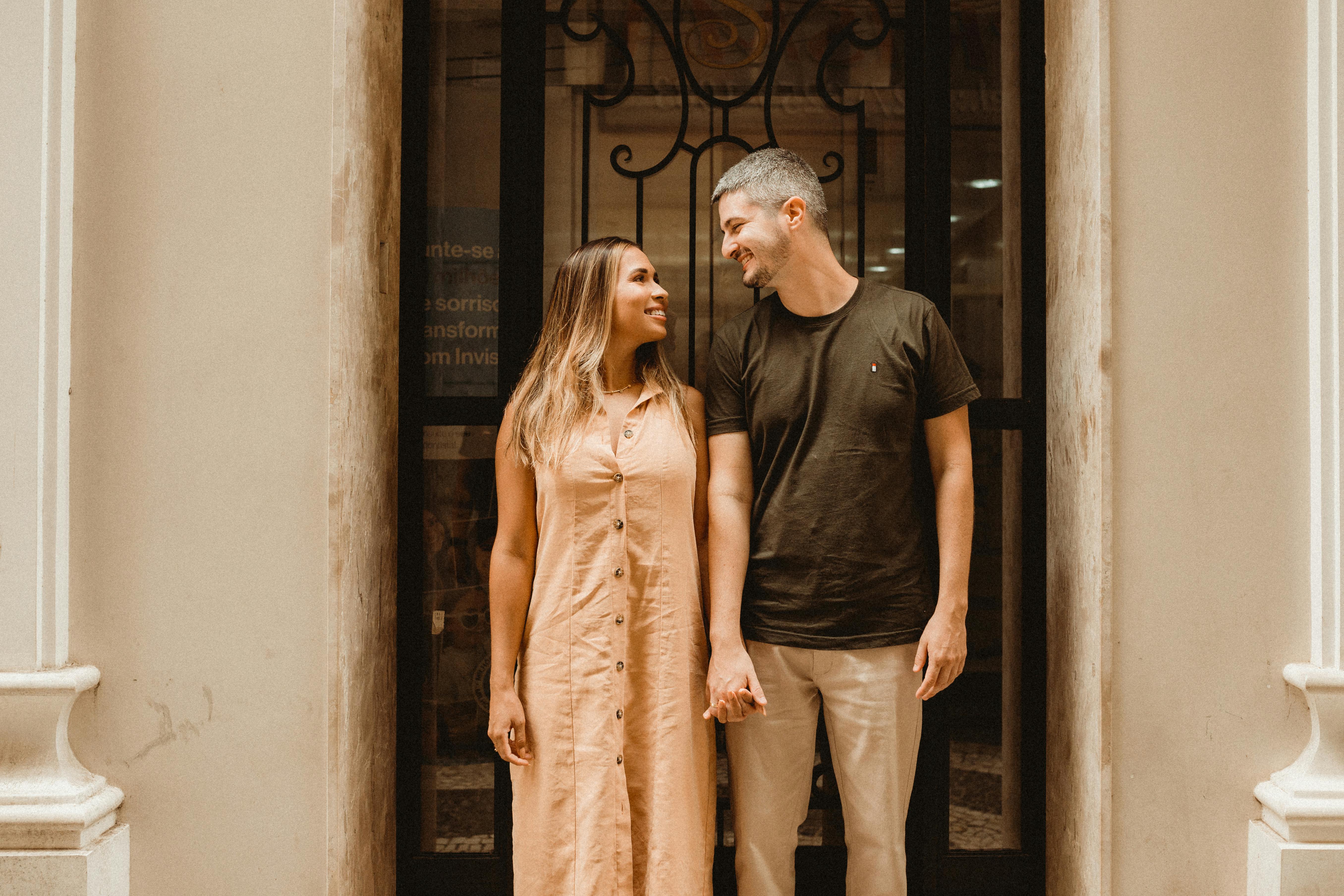 A couple holding hands while looking at each other  | Source: Pexels