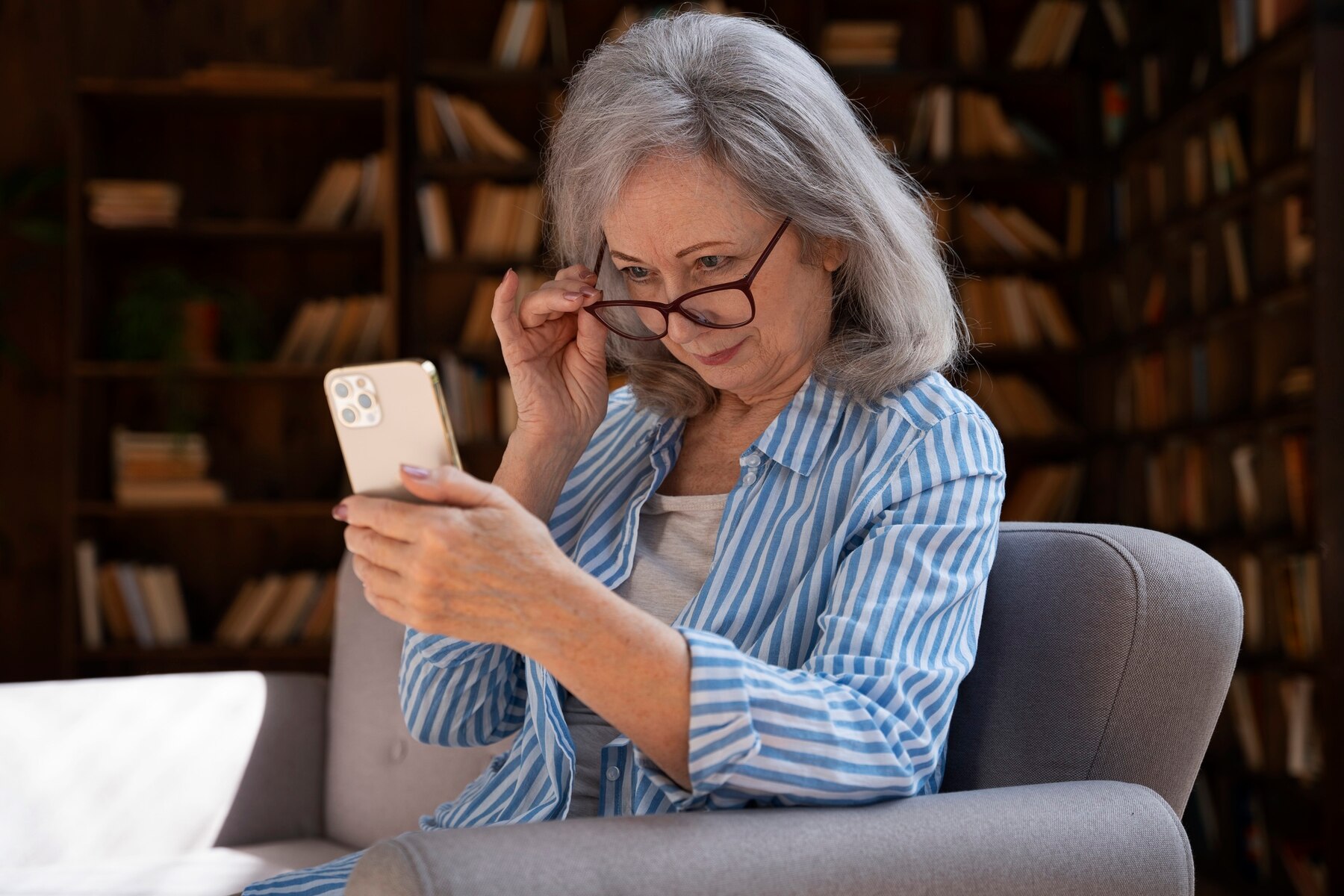 An elderly woman on her phone | Source: Freepik