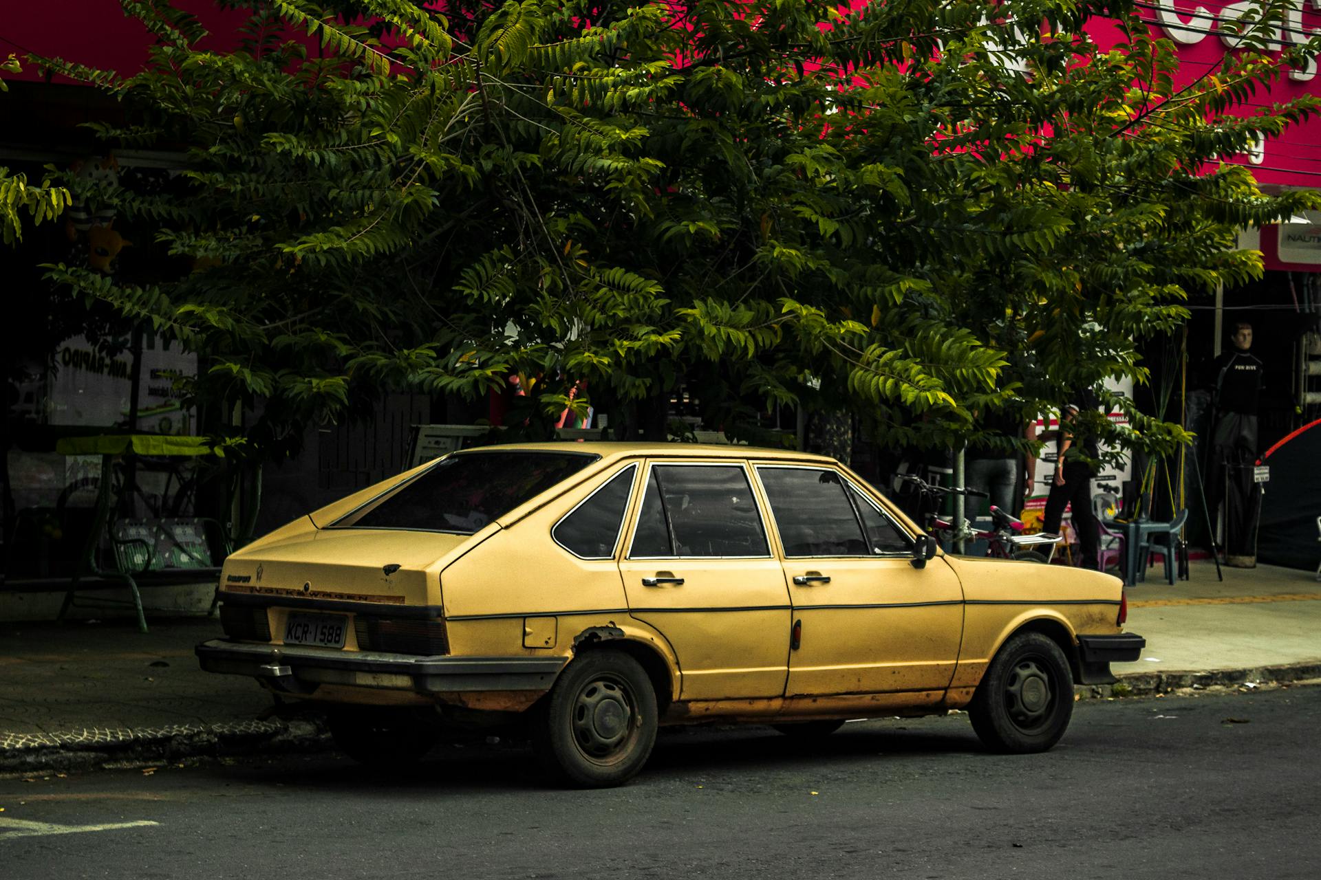 A yellow Sedan parked alongside the road | Source: Pexels