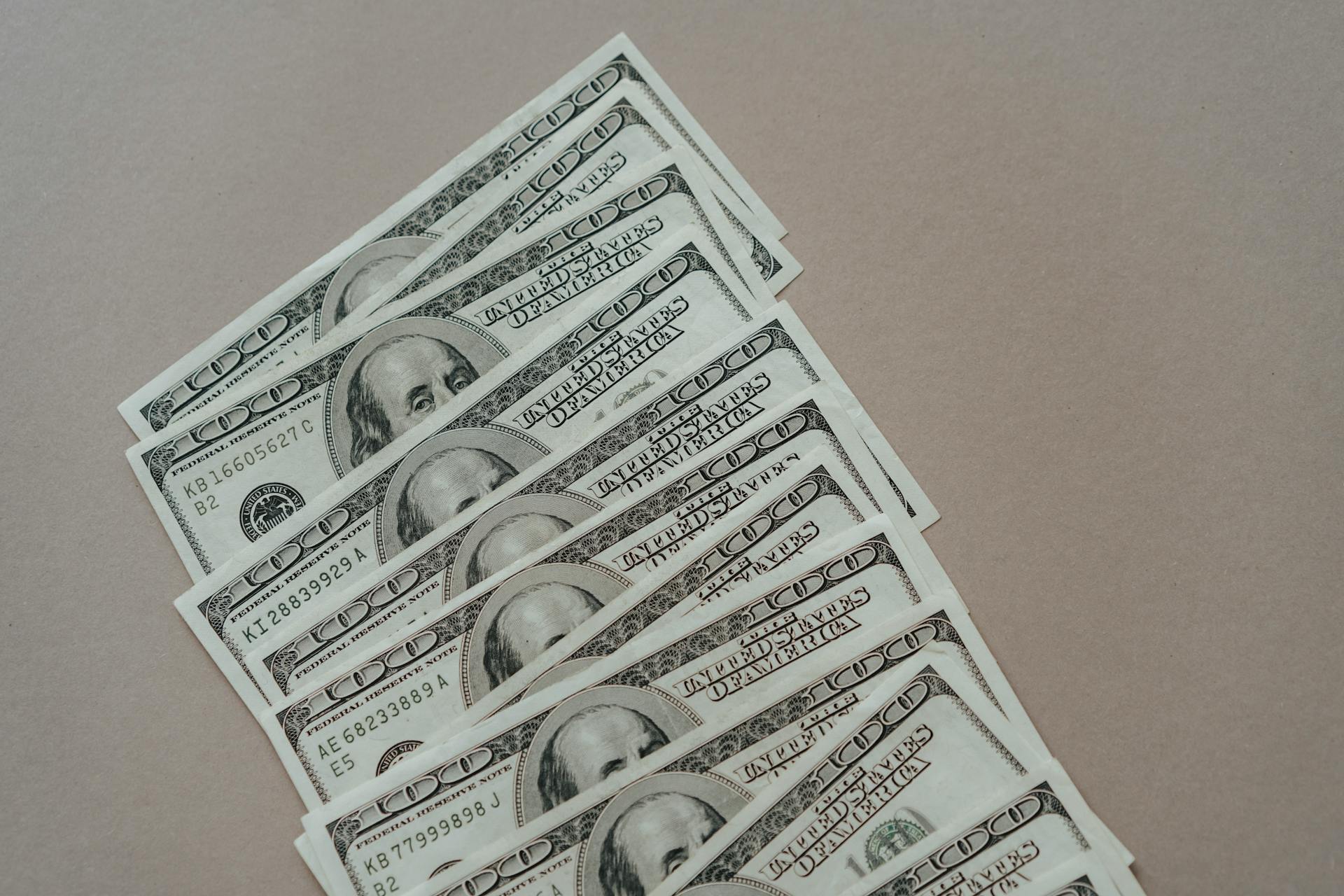 Dollar bills on a gray surface | Source: Pexels