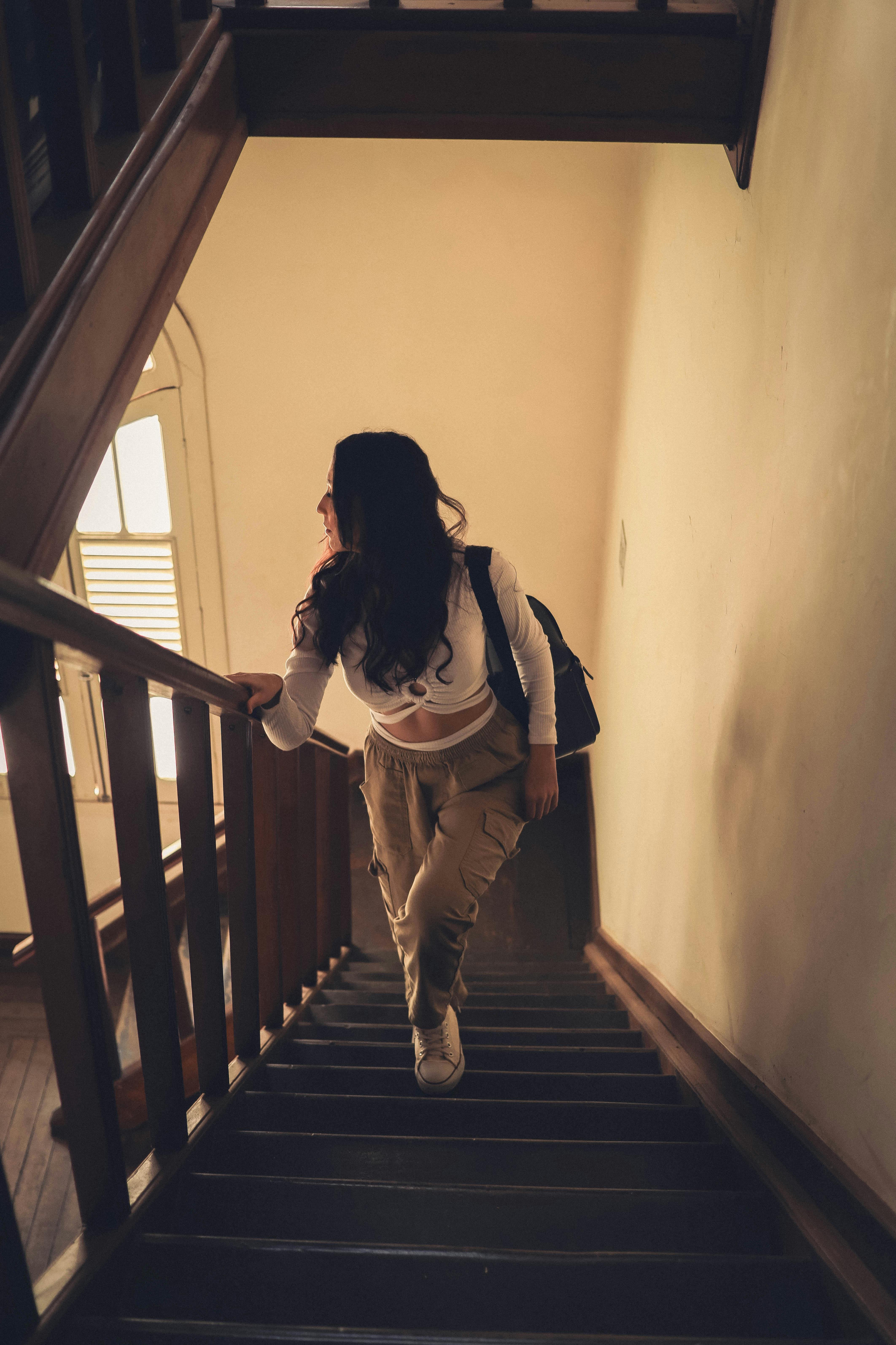 A woman walking up stairs | Source: Pexels