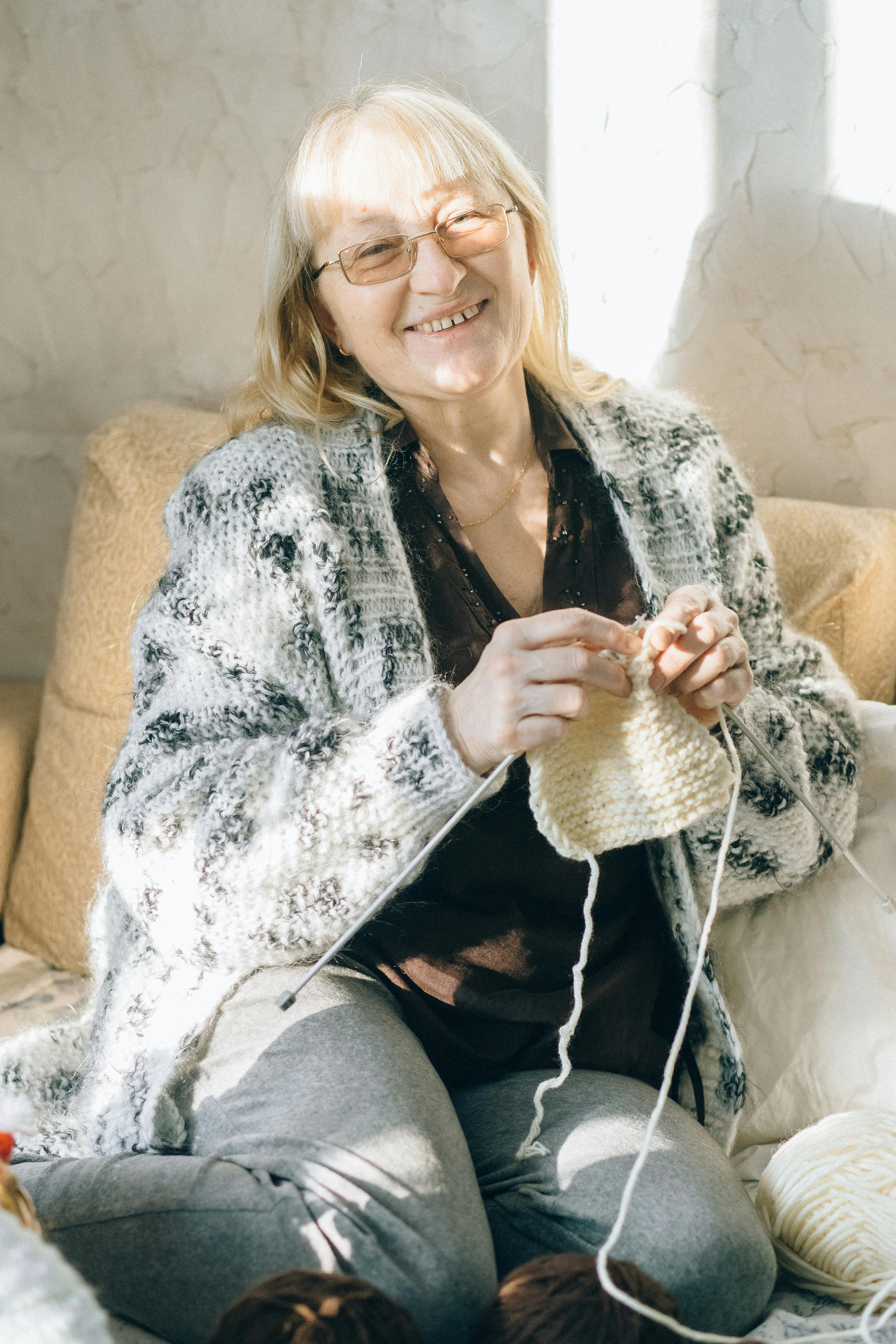 A happy woman knitting | Source: Pexels