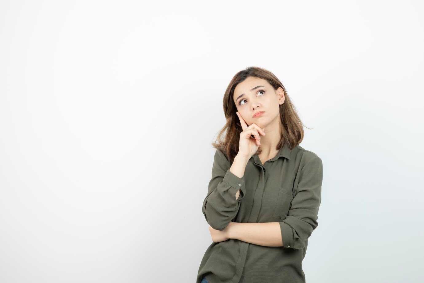 A thoughtful woman looking up | Source: Freepik