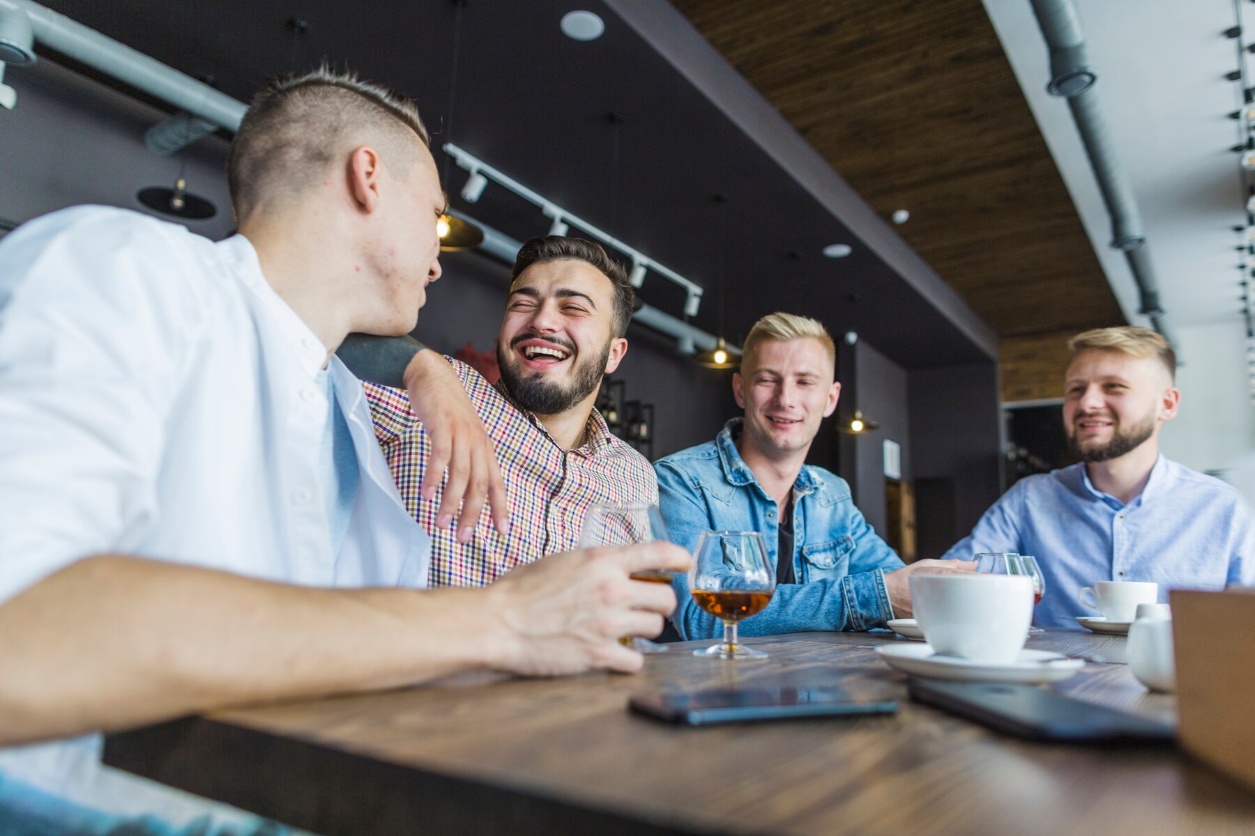 Laughing men in a restaurant | Source: Pexels