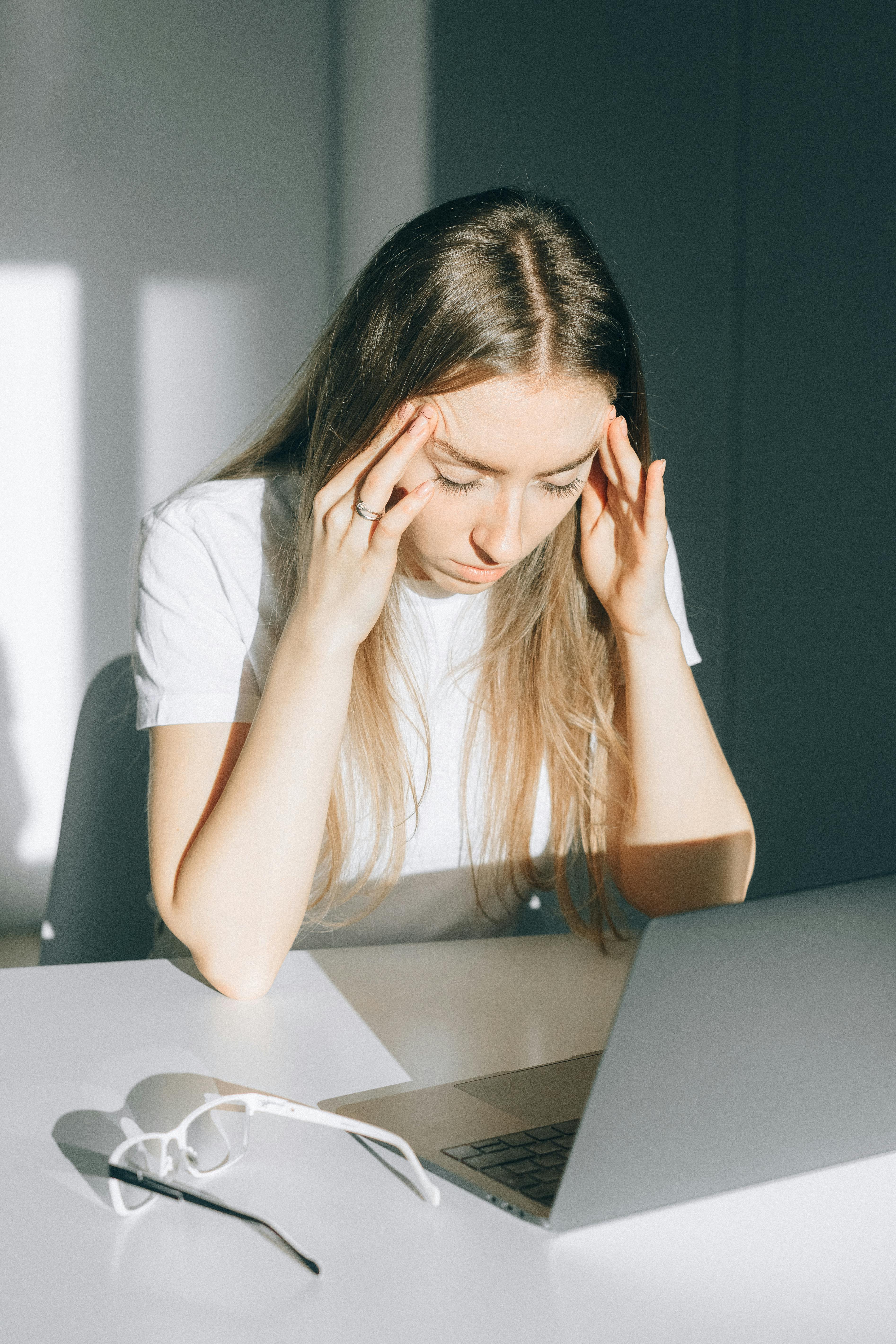 A stressed-out woman in an office | Source: Pexels