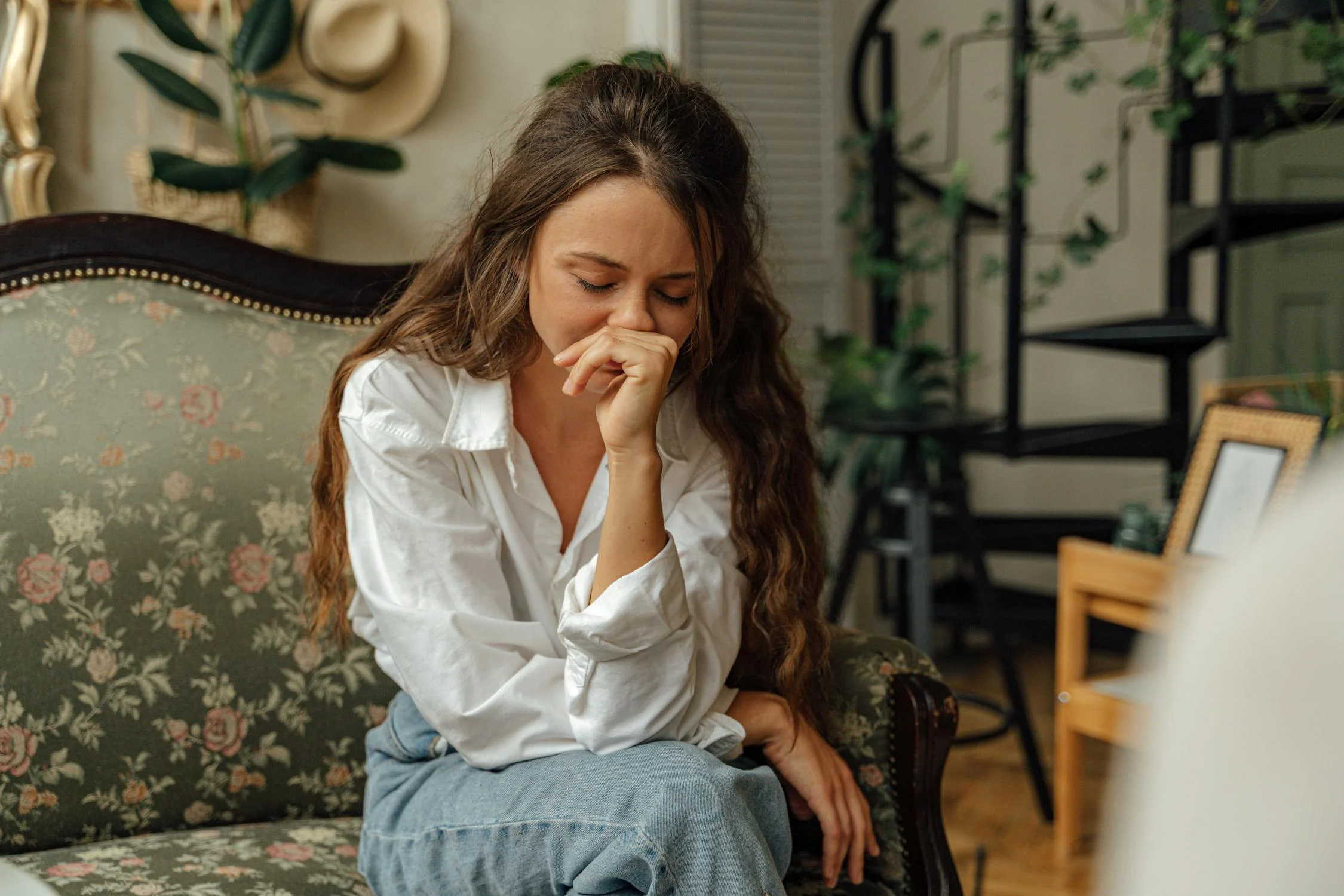 A frustrated woman on a couch | Source: Pexels