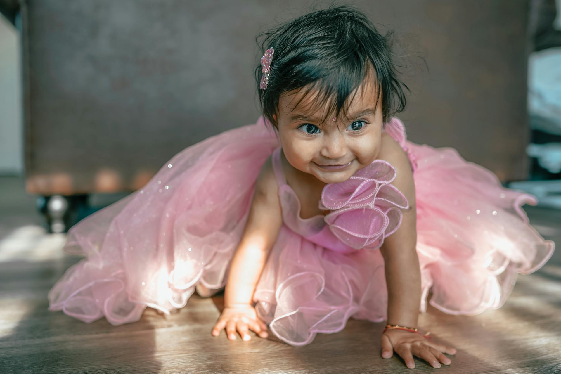 A baby girl in a pink dress | Source: Pexels