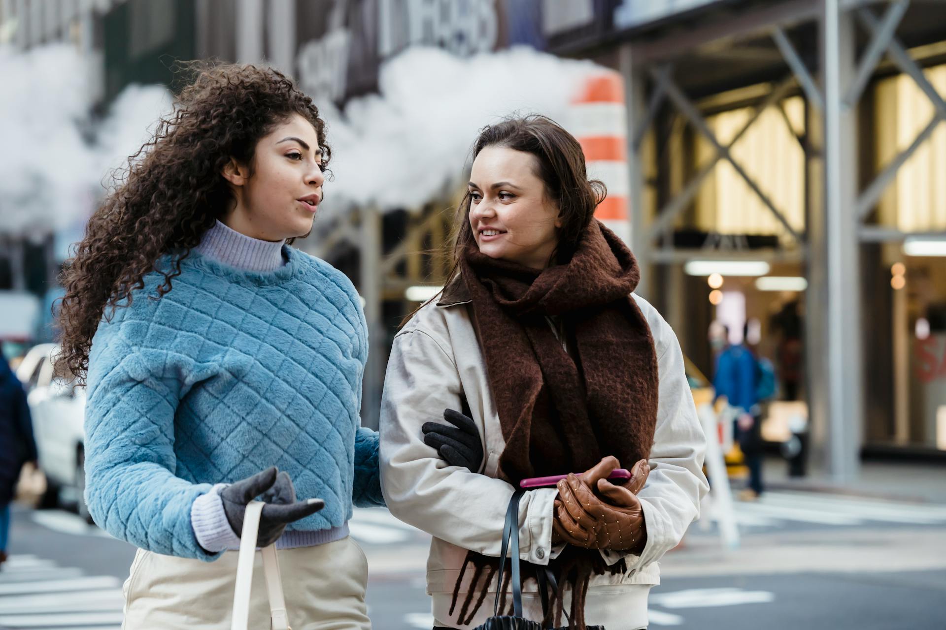 Two women speaking while crossing a street | Source: Pexels