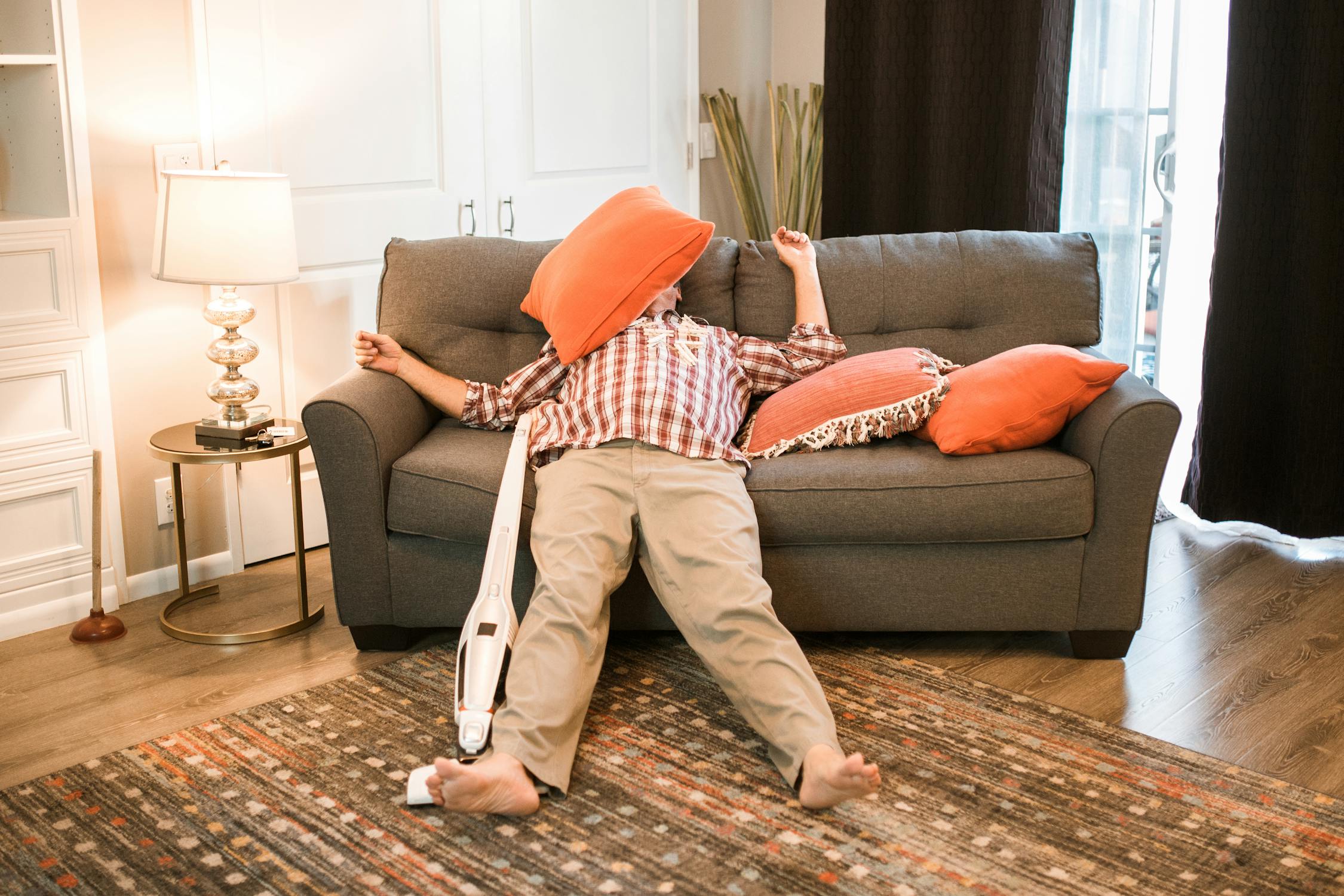 A tired man lying on the couch | Source: Pexels