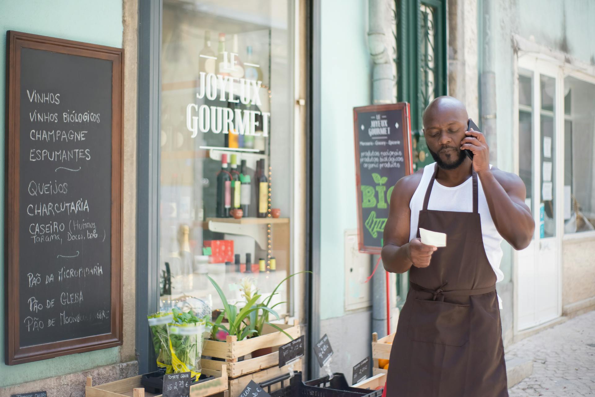 A man holding a note while making a phone call | Source: Pexels