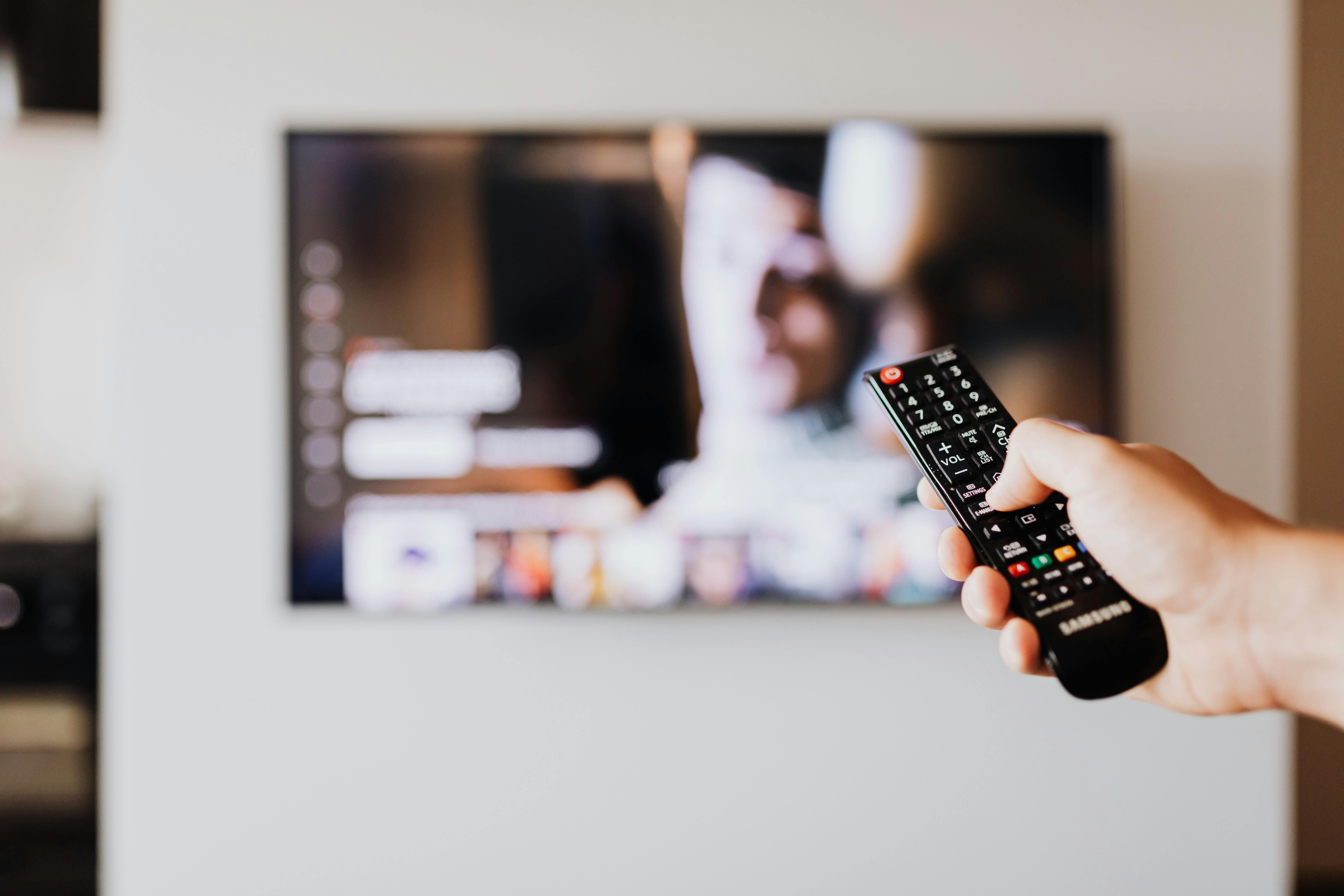 A man scrolling through the TV | Source: Pexels