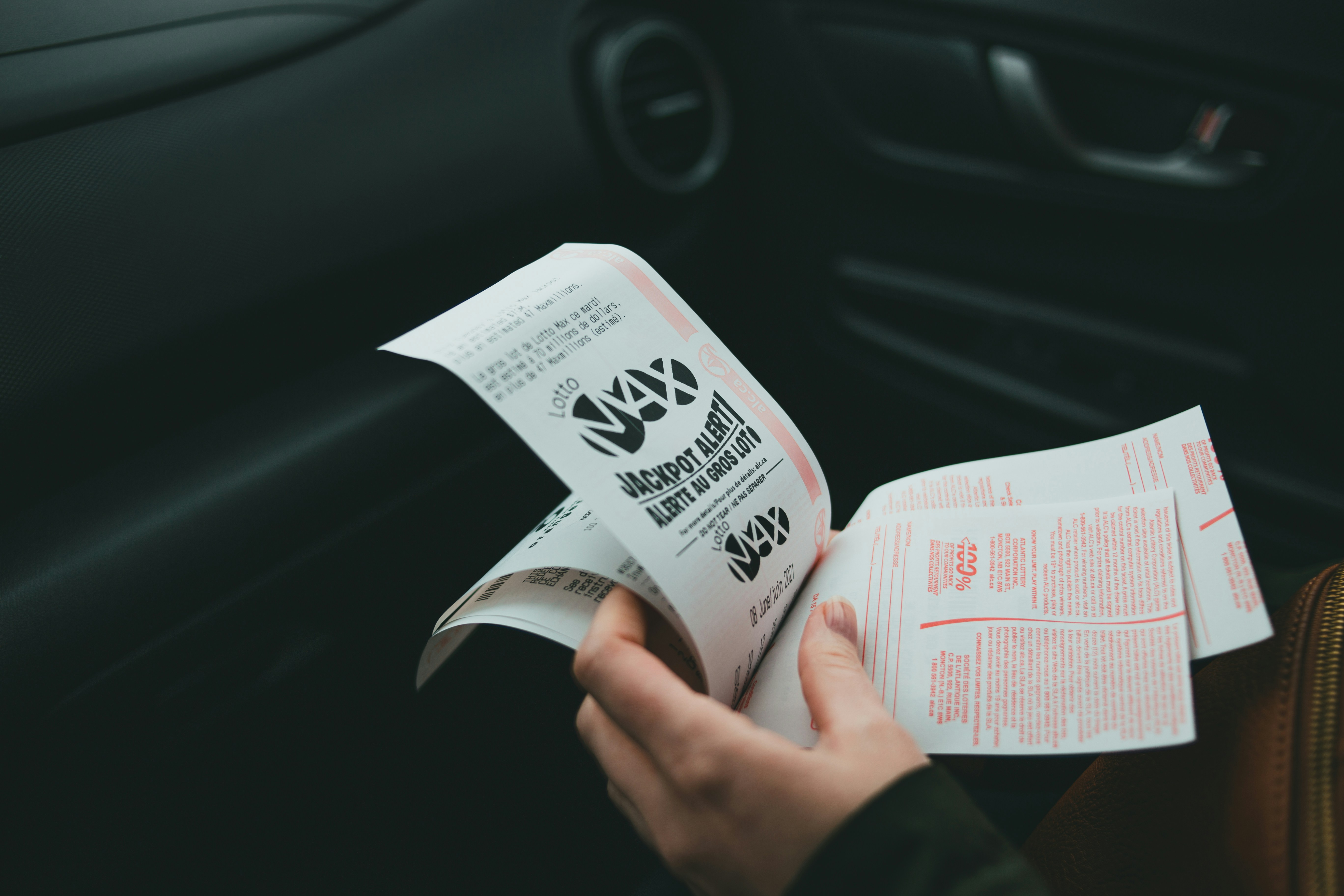 A person holding lottery tickets | Source: Unsplash