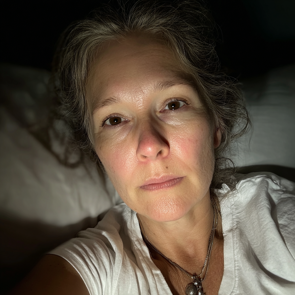 A woman laying in her bed | Source: Midjourney