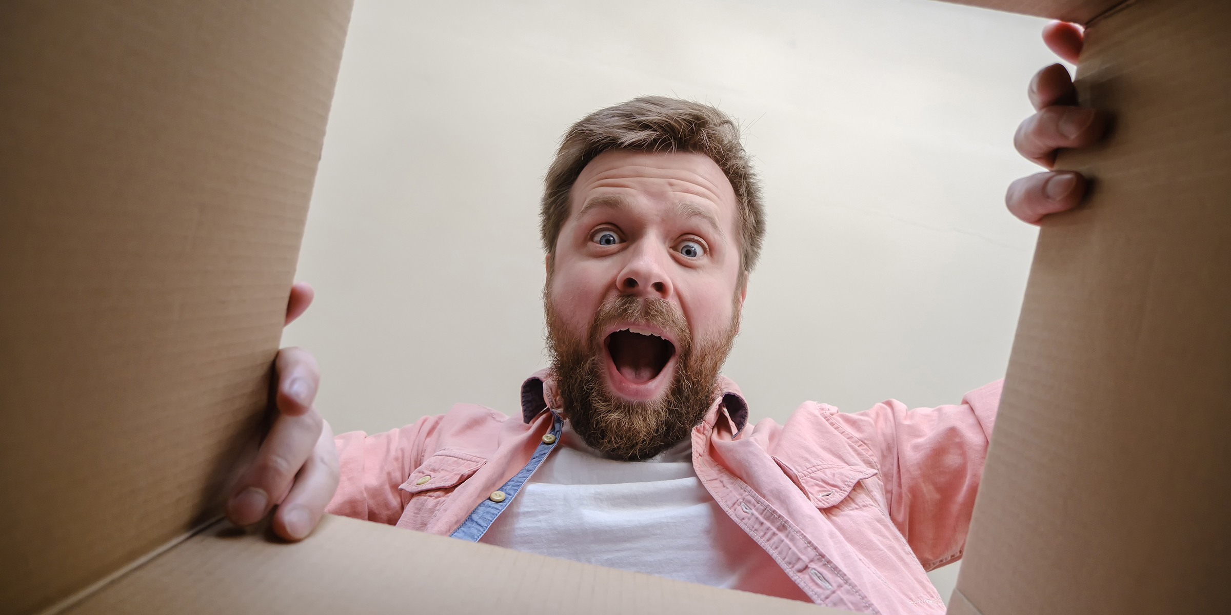 Surprised man opening a gift | Source: Shutterstock