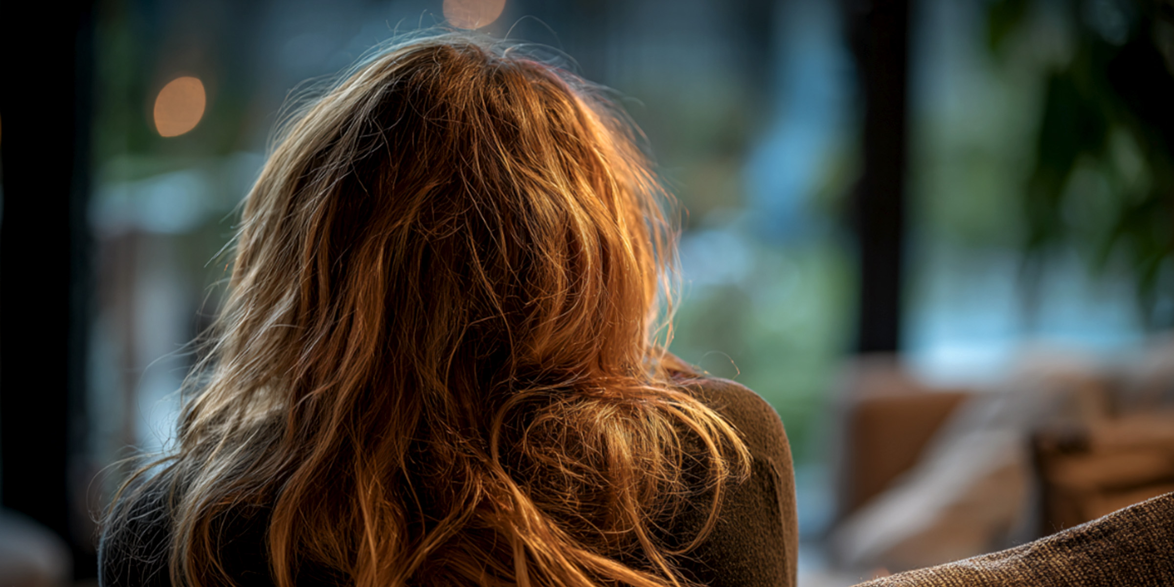 A woman sitting in silence gazing out the window, lost in thought | Source: The Celebritist