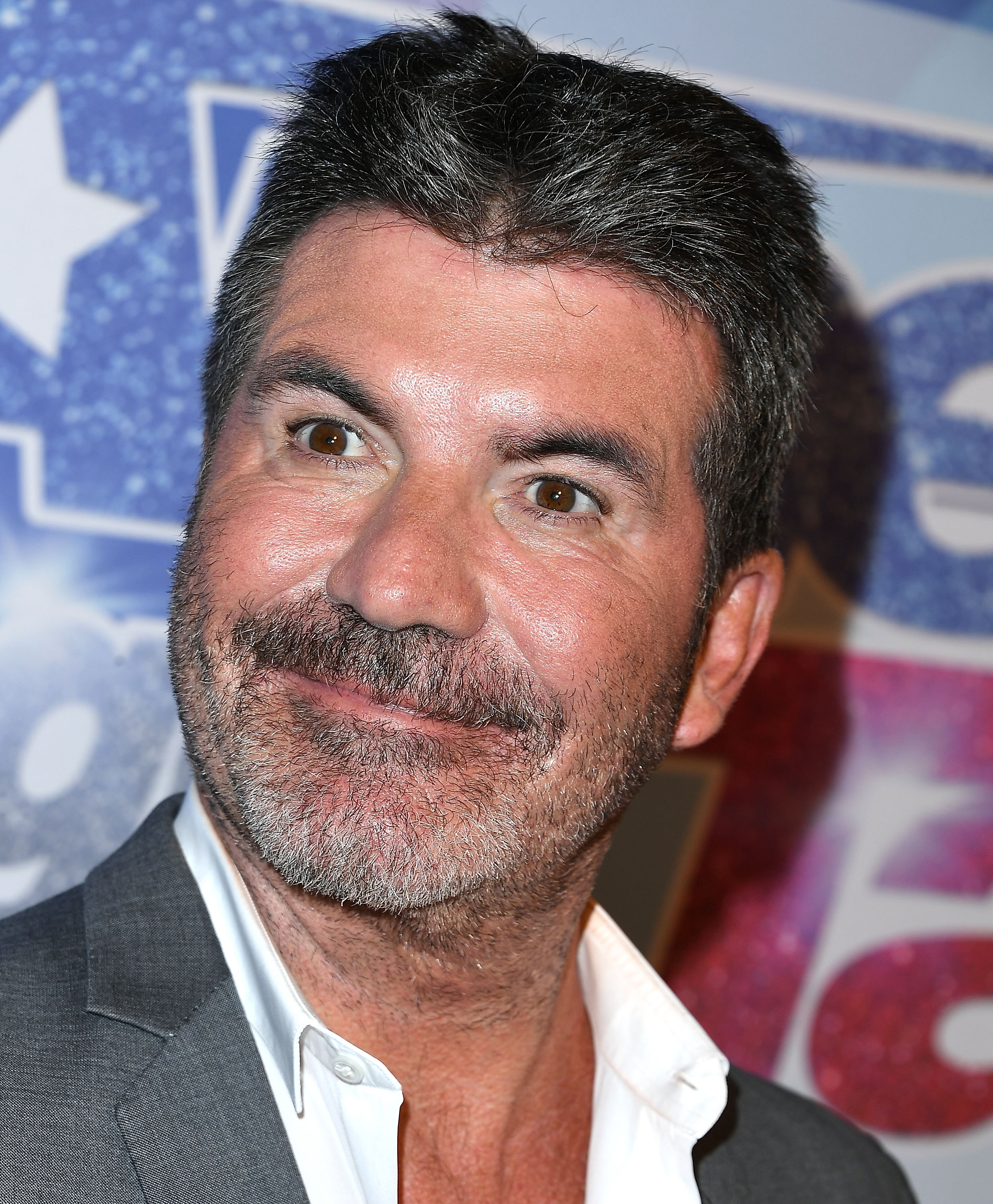 Cowell is pictured in 2017, years before he admitted that he felt he had gone too far with facial filler. He later said an old photo helped make him reconsider his approach to cosmetic treatments. | Source: Getty Images