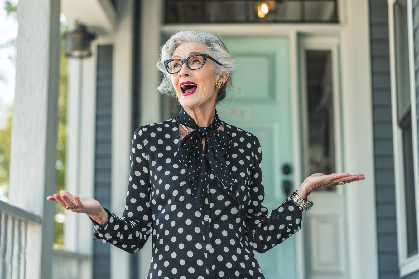 A woman speaking to someone on a front porch | Source: Midjourney