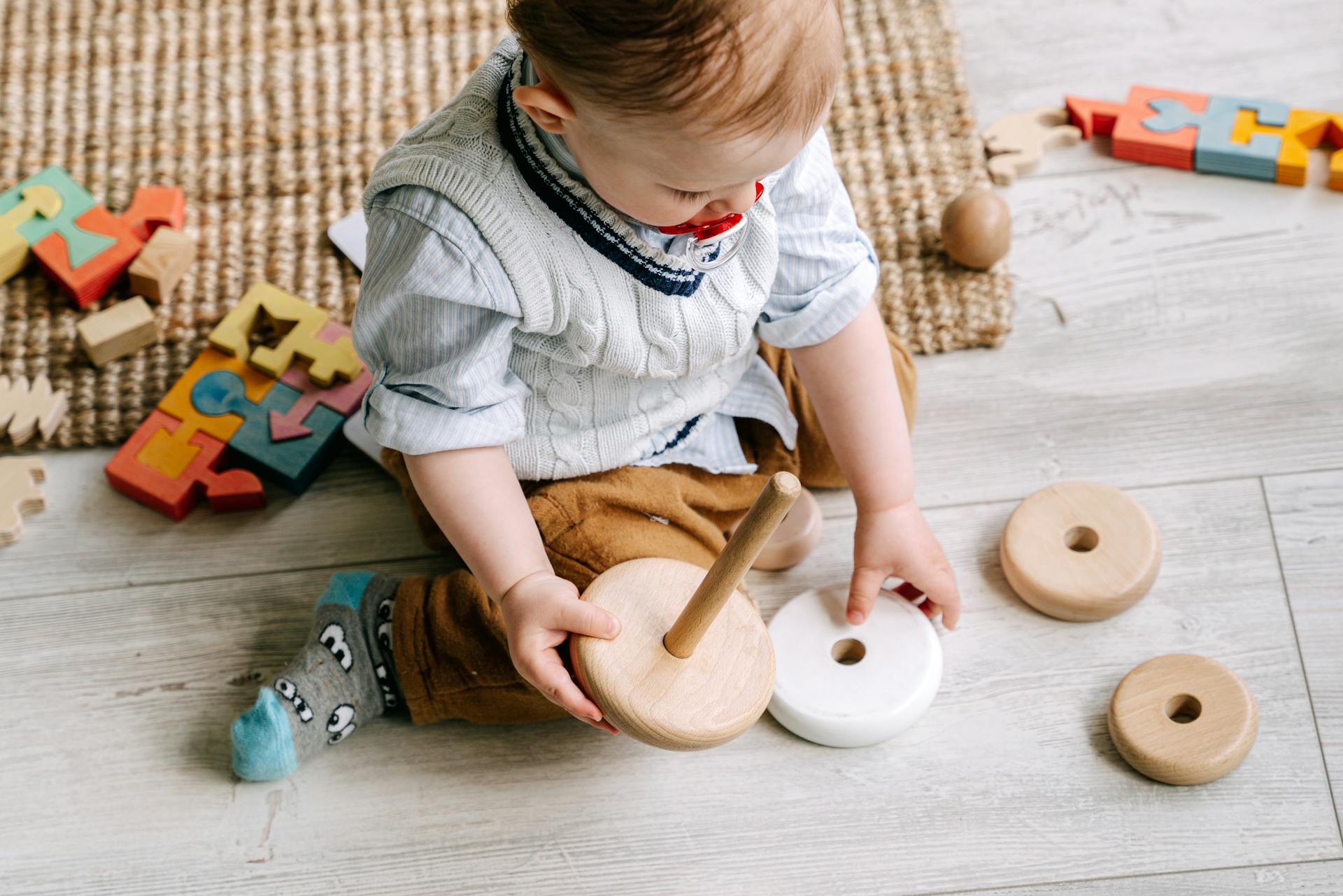 A baby boy playing with his toys | Source: Pexels