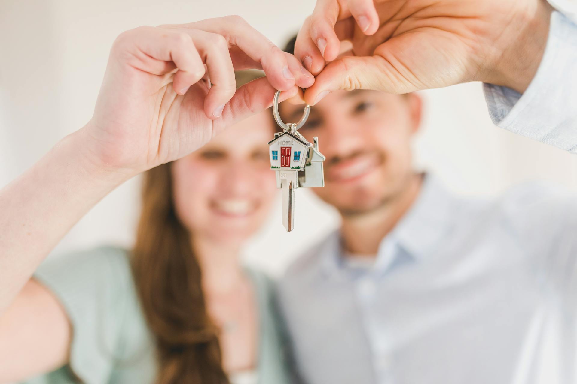 A delighted couple holding their house key | Source: Pexels