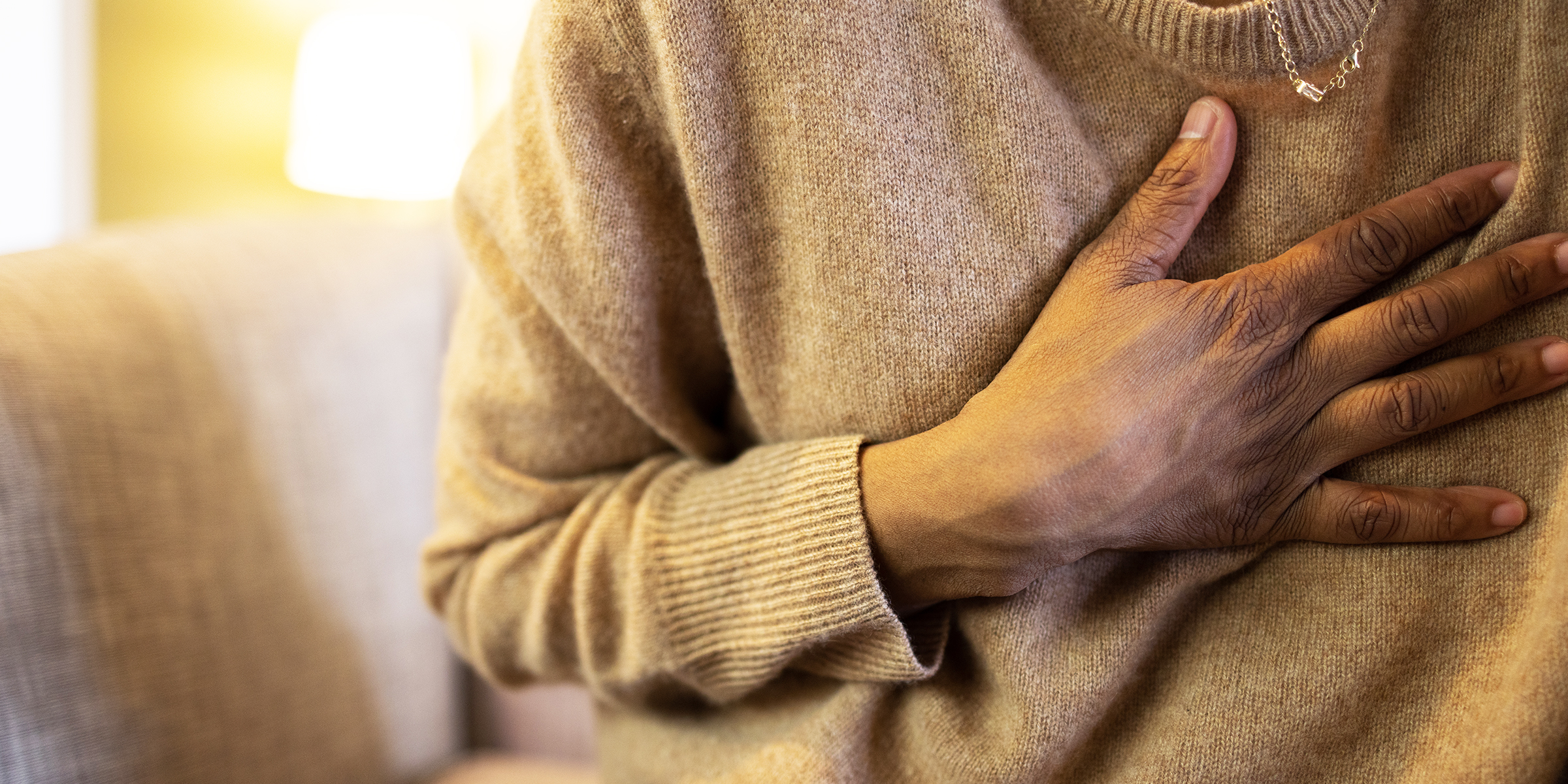 A person with a hand on their chest | Getty Images