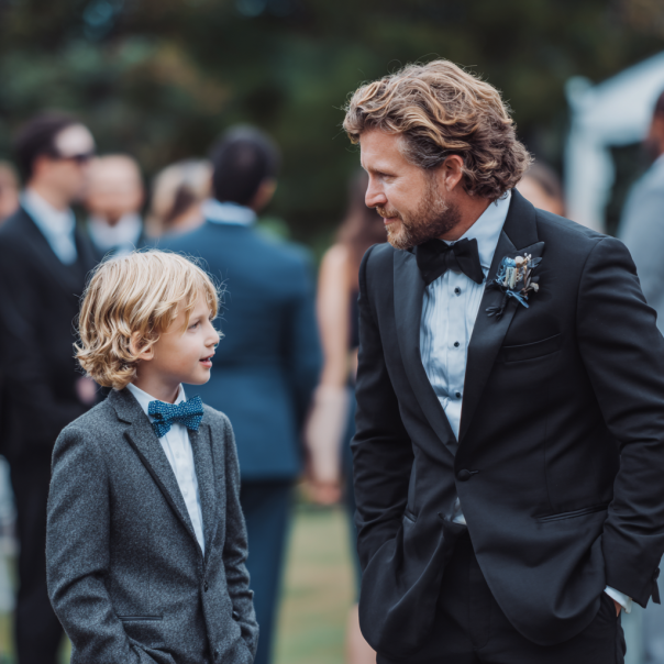 A father and son talking at a wedding | Source: Midjourney