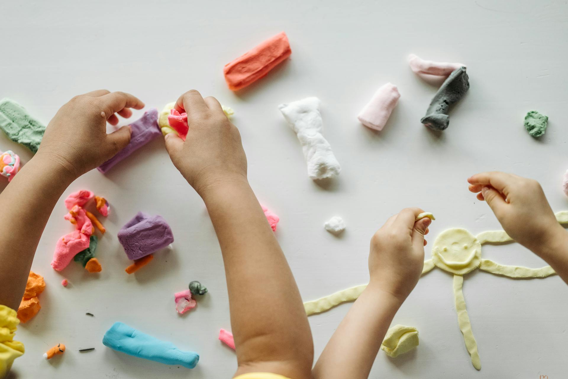 Children playing with clay | Source: Pexels