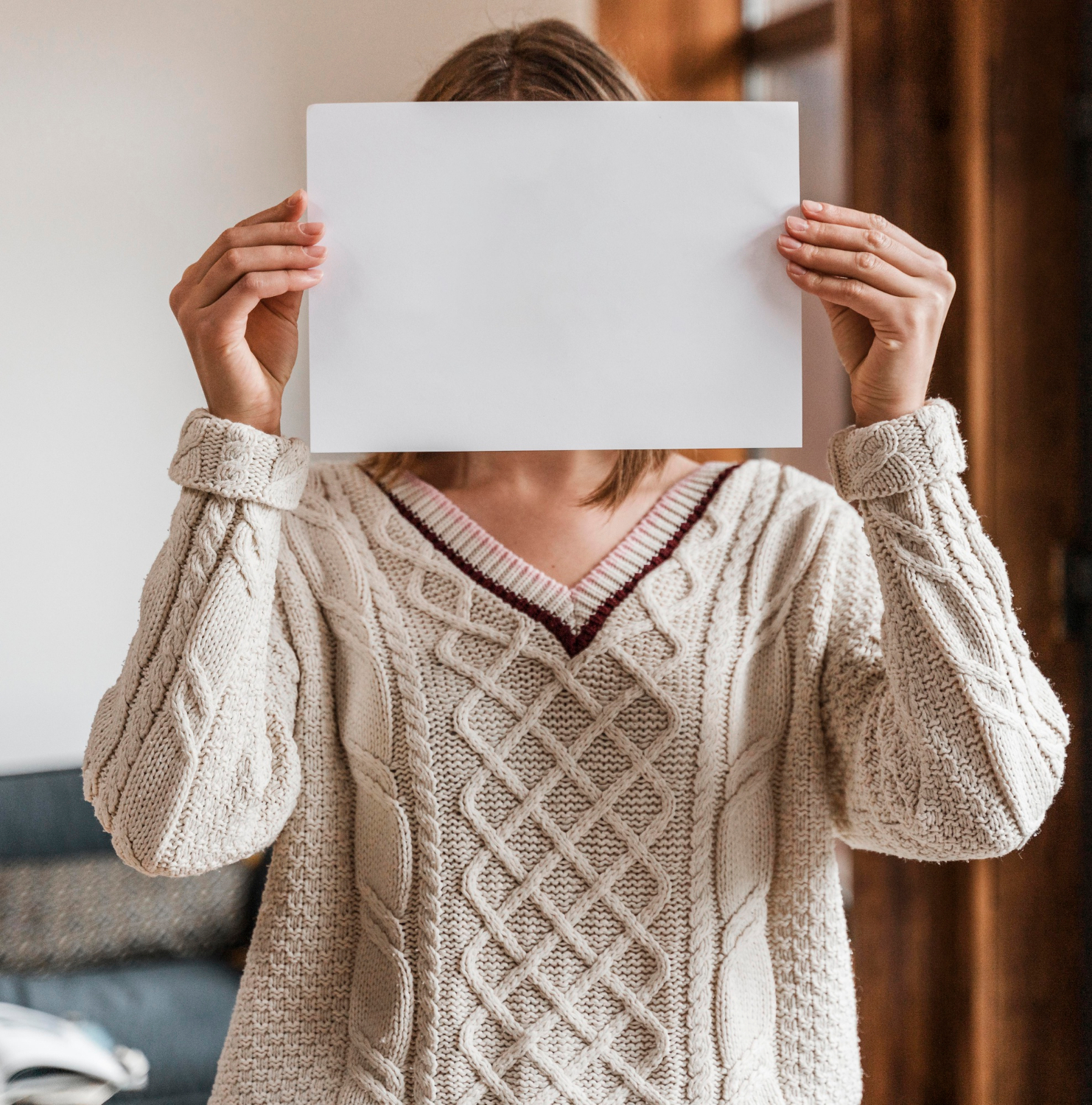 A woman holding a sheet of paper | Source: Freepik