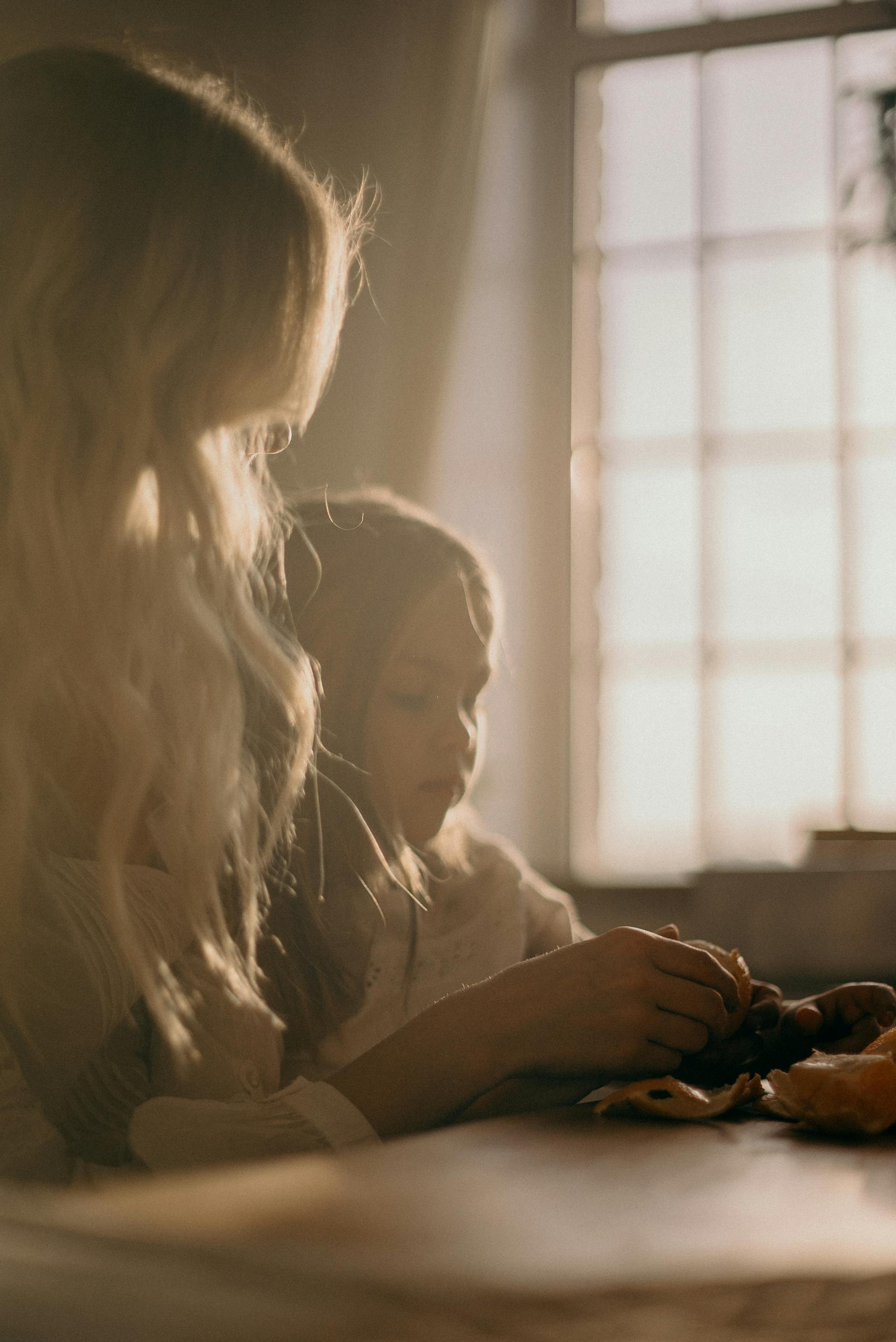 A woman sitting with a child | Source: Pexels