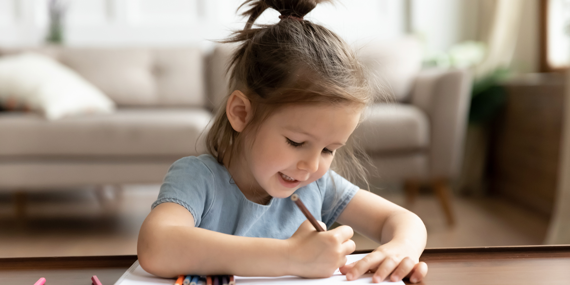 A little girl writing something | Source: Shutterstock