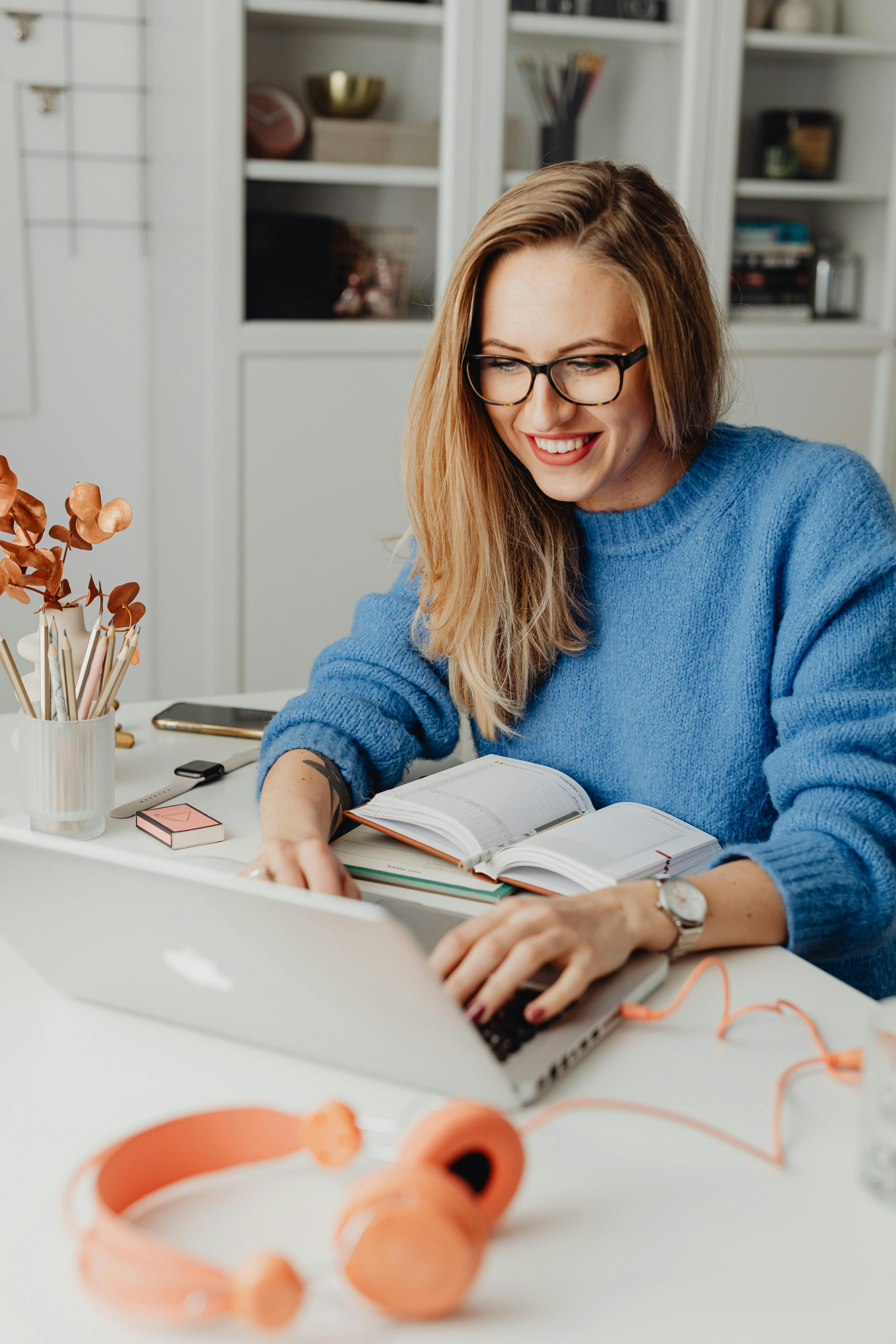 A happy woman working on a laptop | Source: Pexels