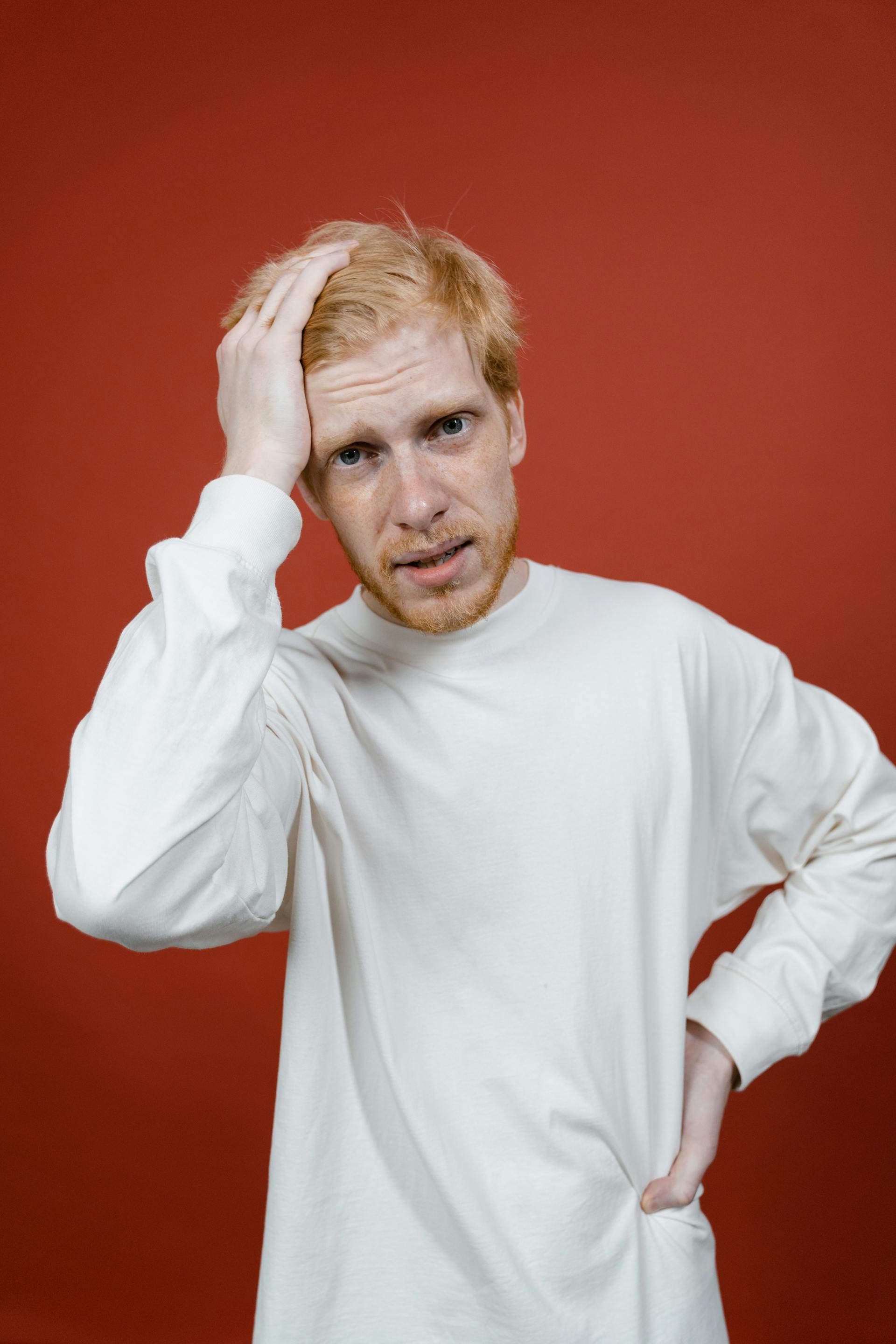 A frustrated man running his hand through his hair | Source: Pexels