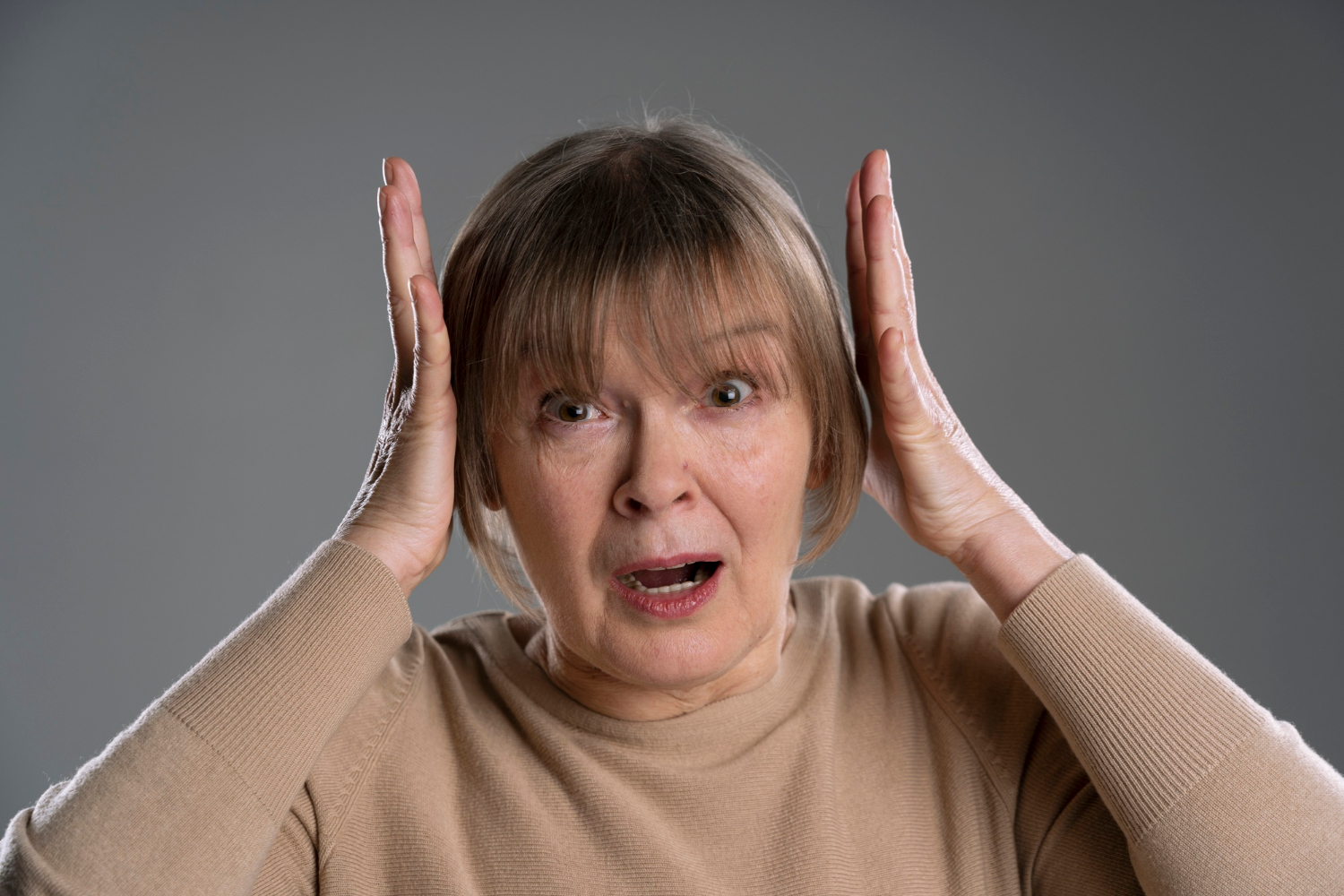 A terrorized older woman | Source: Freepik