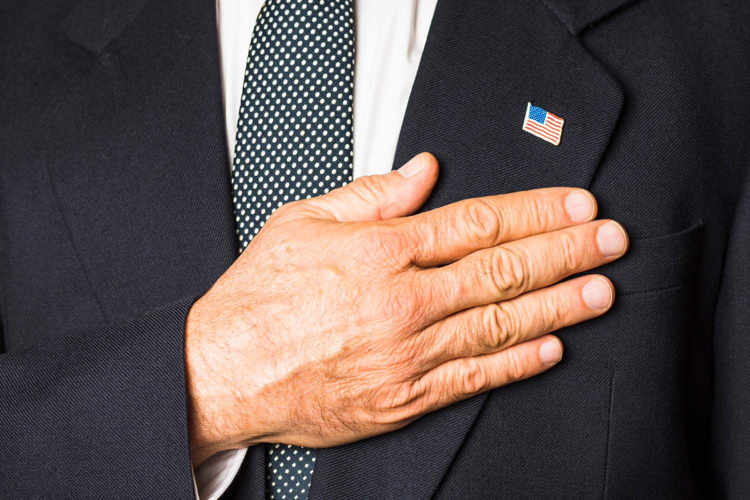 An older man placing his hand on his chest | Source: Freepik