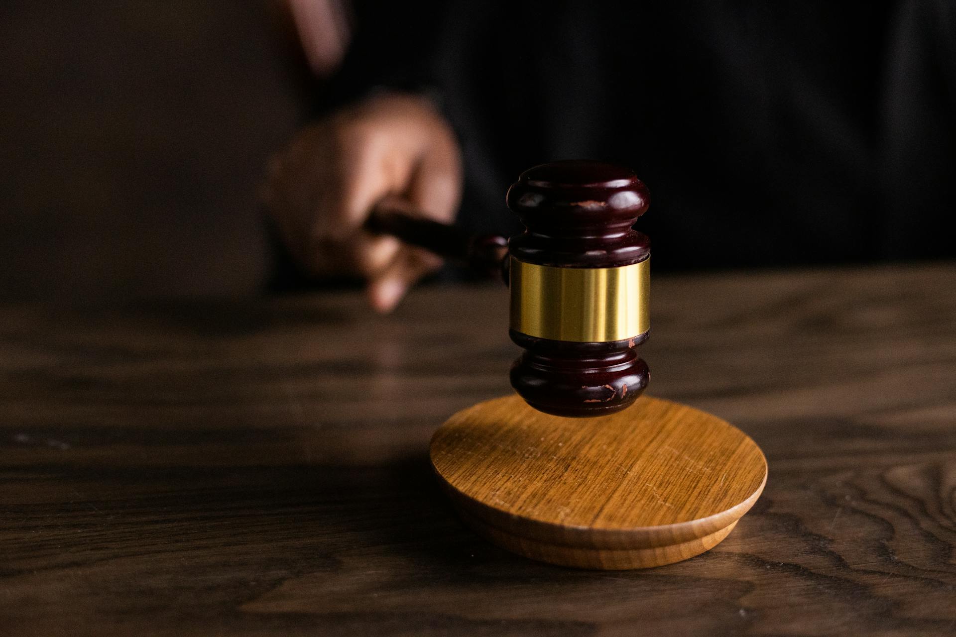 Close-up shot of a judge holding a wooden gavel | Source: Pexels