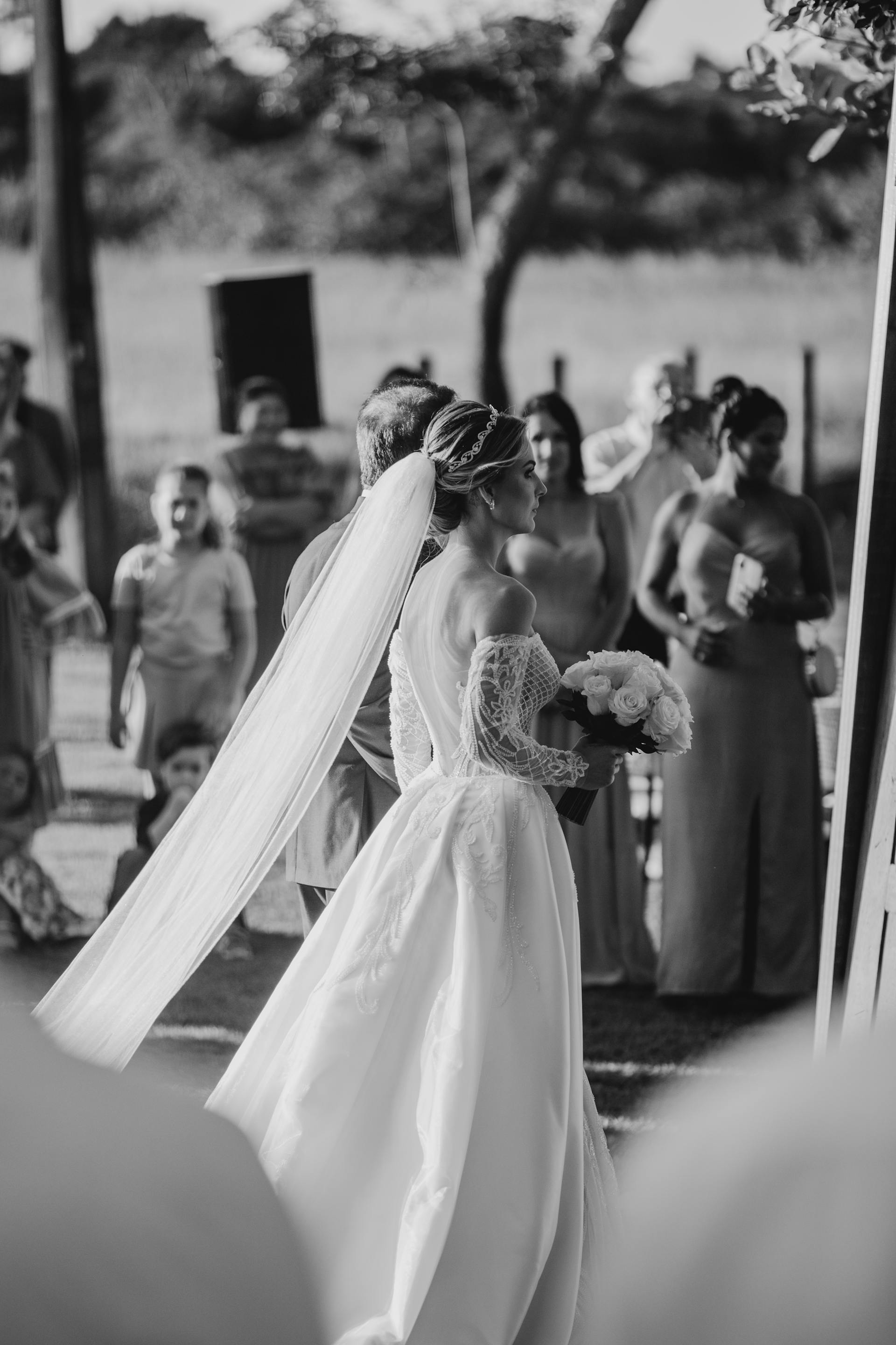 A grayscale photo of a bride walking down the aisle | Source: Pexels