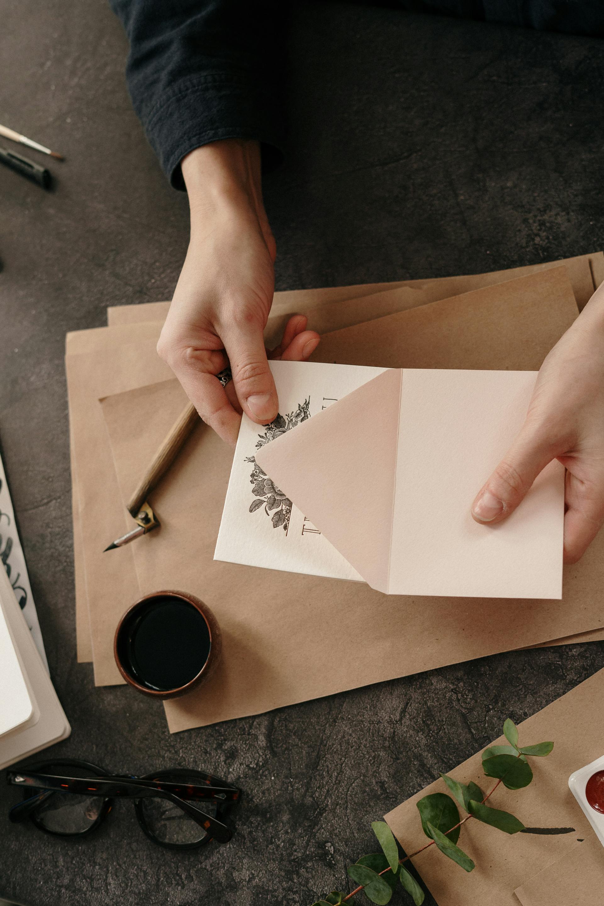 A closeup shot of a person taking out a card from an envelope | Source: Pexels