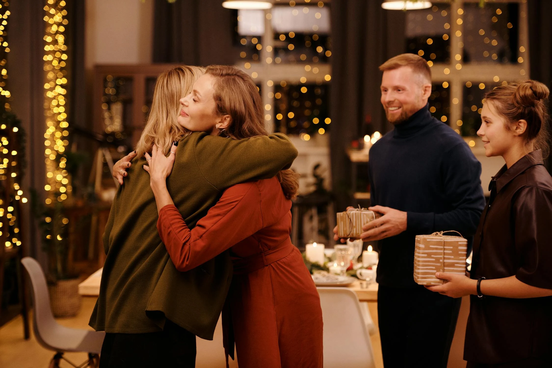 Guests hugging in the living room | Source: Pexels