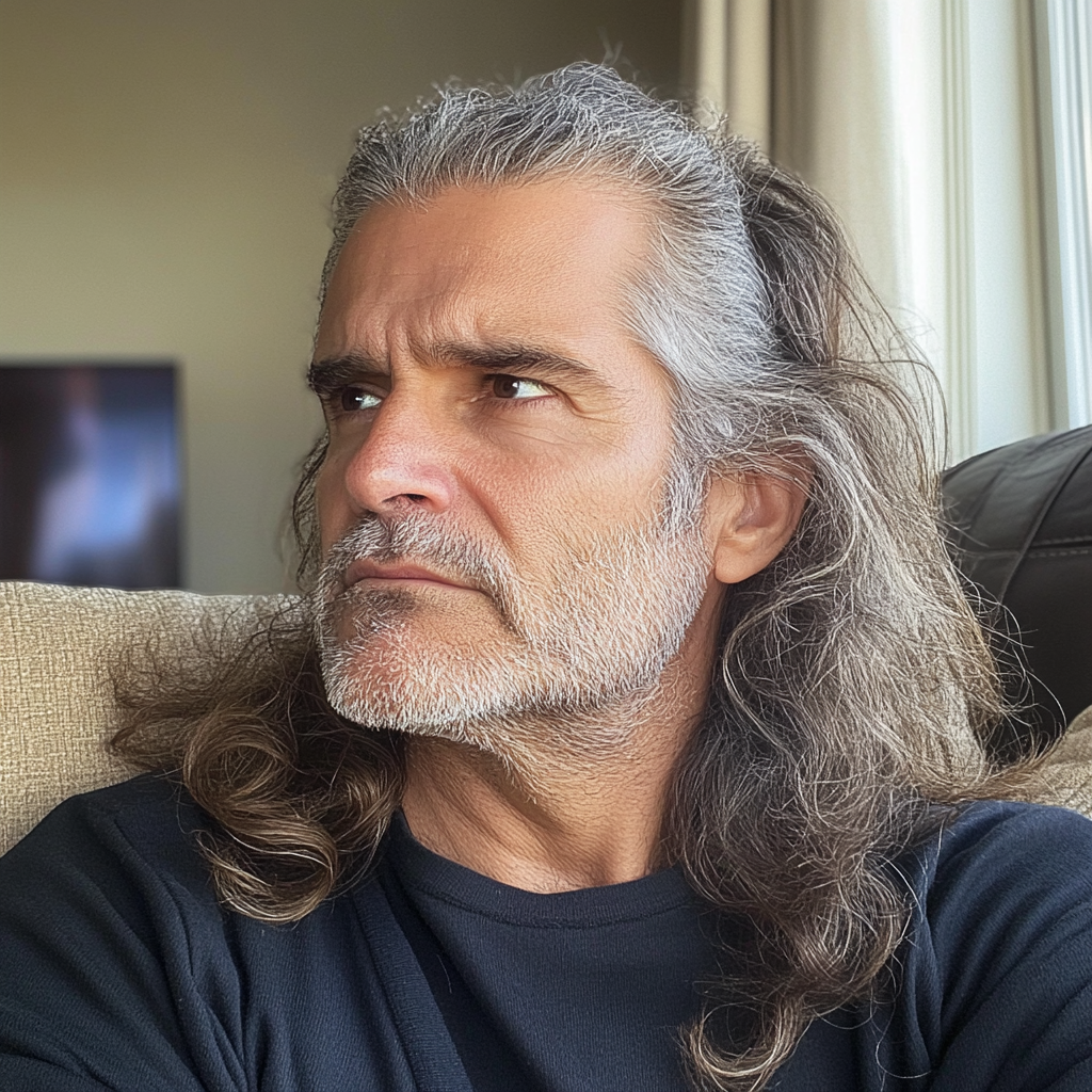 A man sitting on a couch | Source: Midjourney