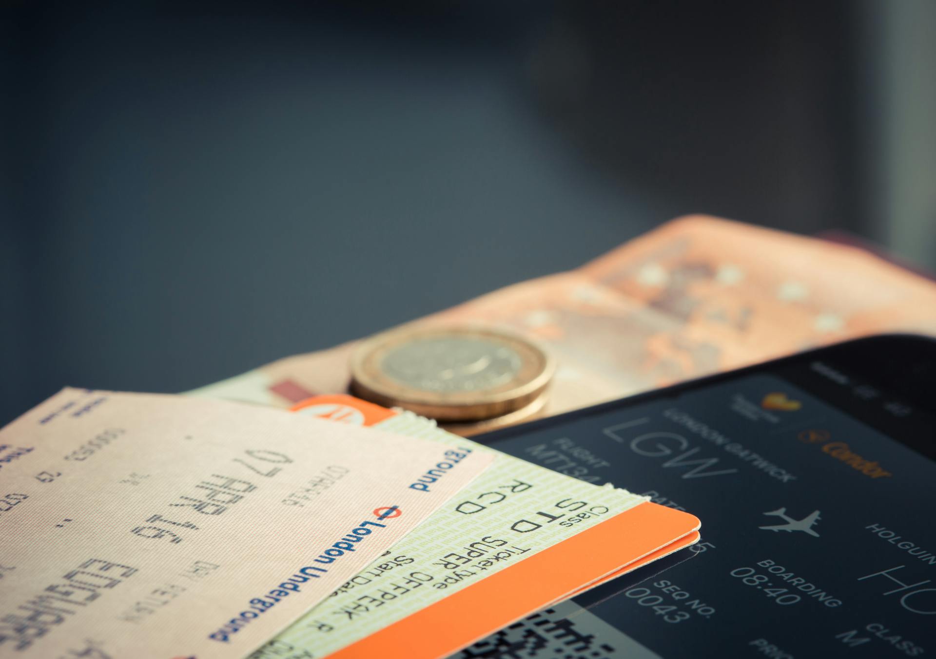 A plane ticket and a coin | Source: Pexels