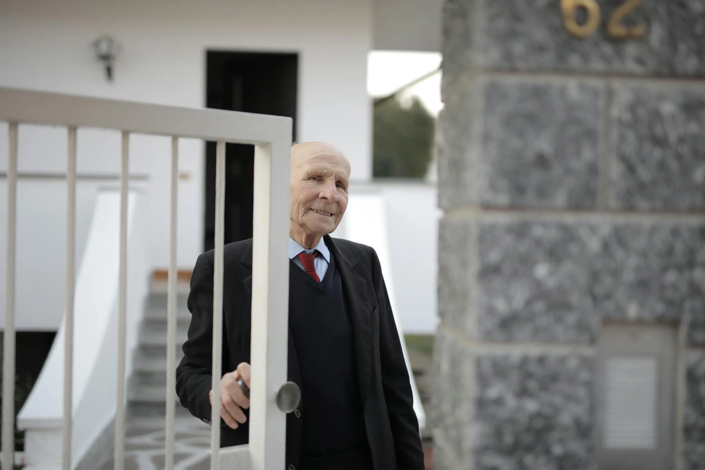 An elderly man outside of his house | Source: Pexels