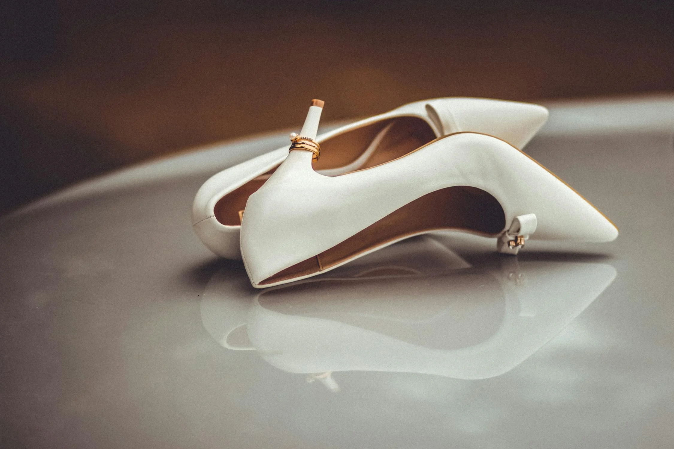 Wedding shoes with rings attached to the heel | Source: Pexels