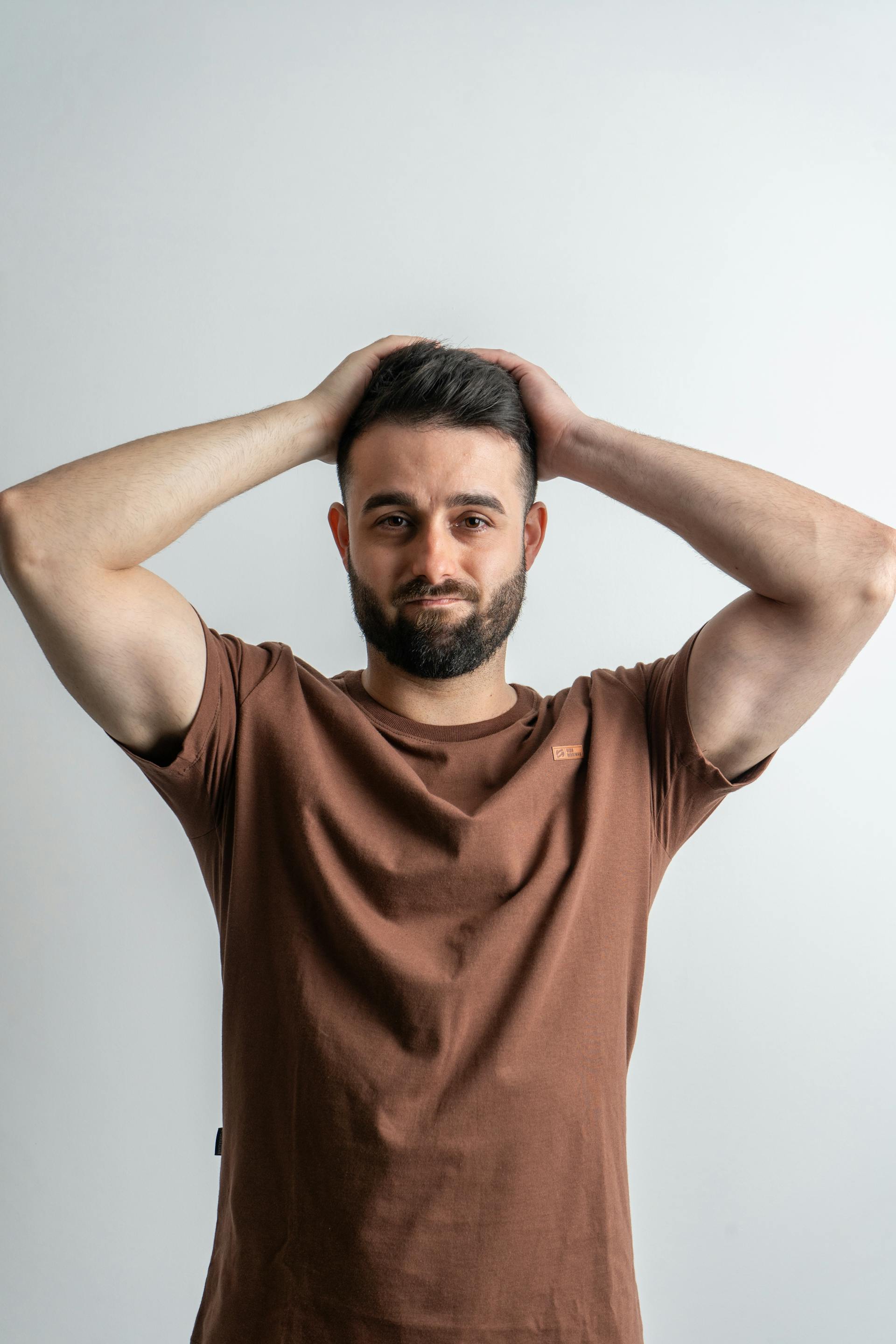 A man with his hands on his head | Source: Pexels