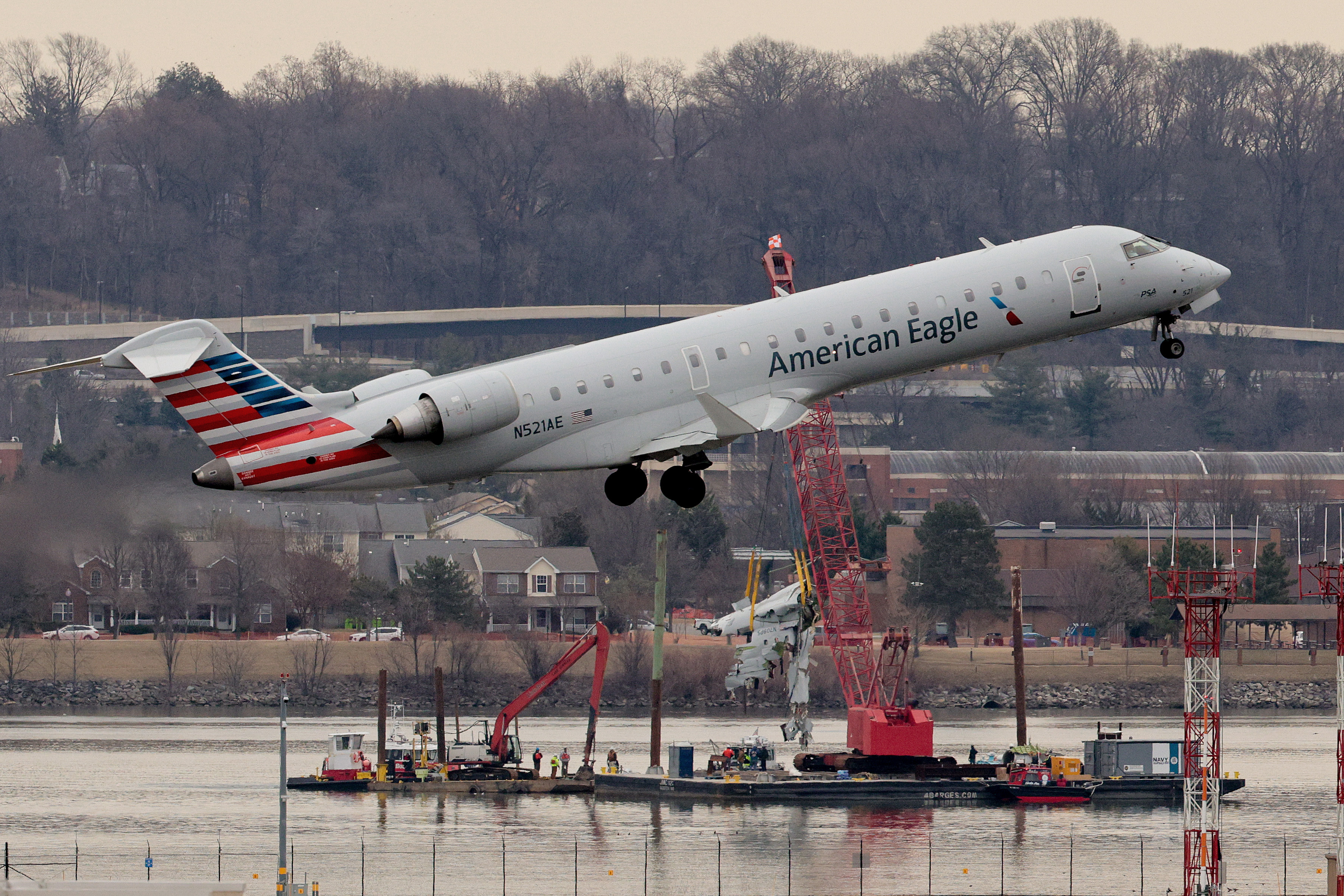 An airplane takes off as recovery efforts continue after the American Airlines plane and Black Hawk helicopter crash near Reagan National Airport on February 3, 2025, in Arlington, Virginia | Source: Getty Images