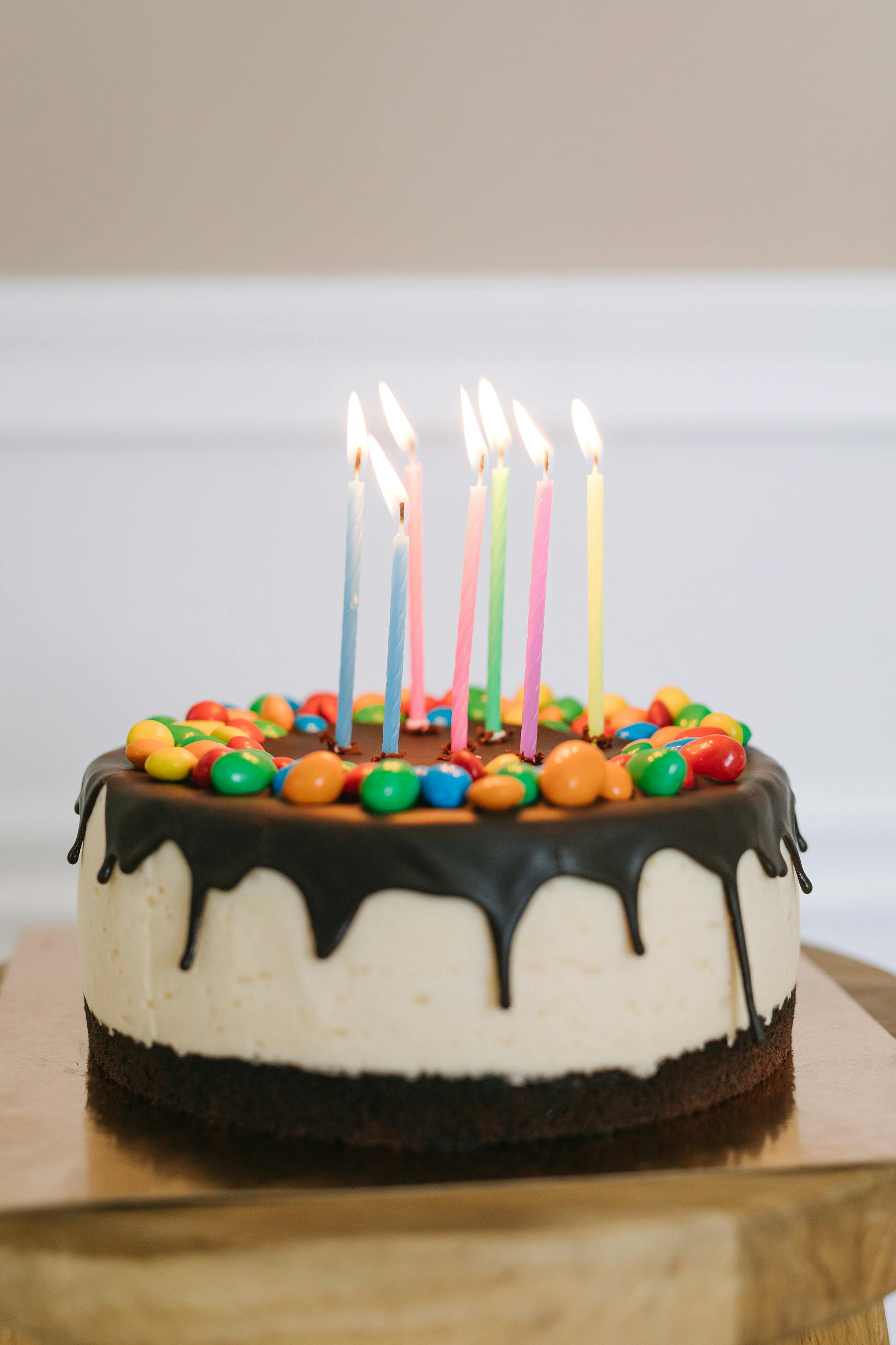 A cake with lighted candles | Source: Pexels